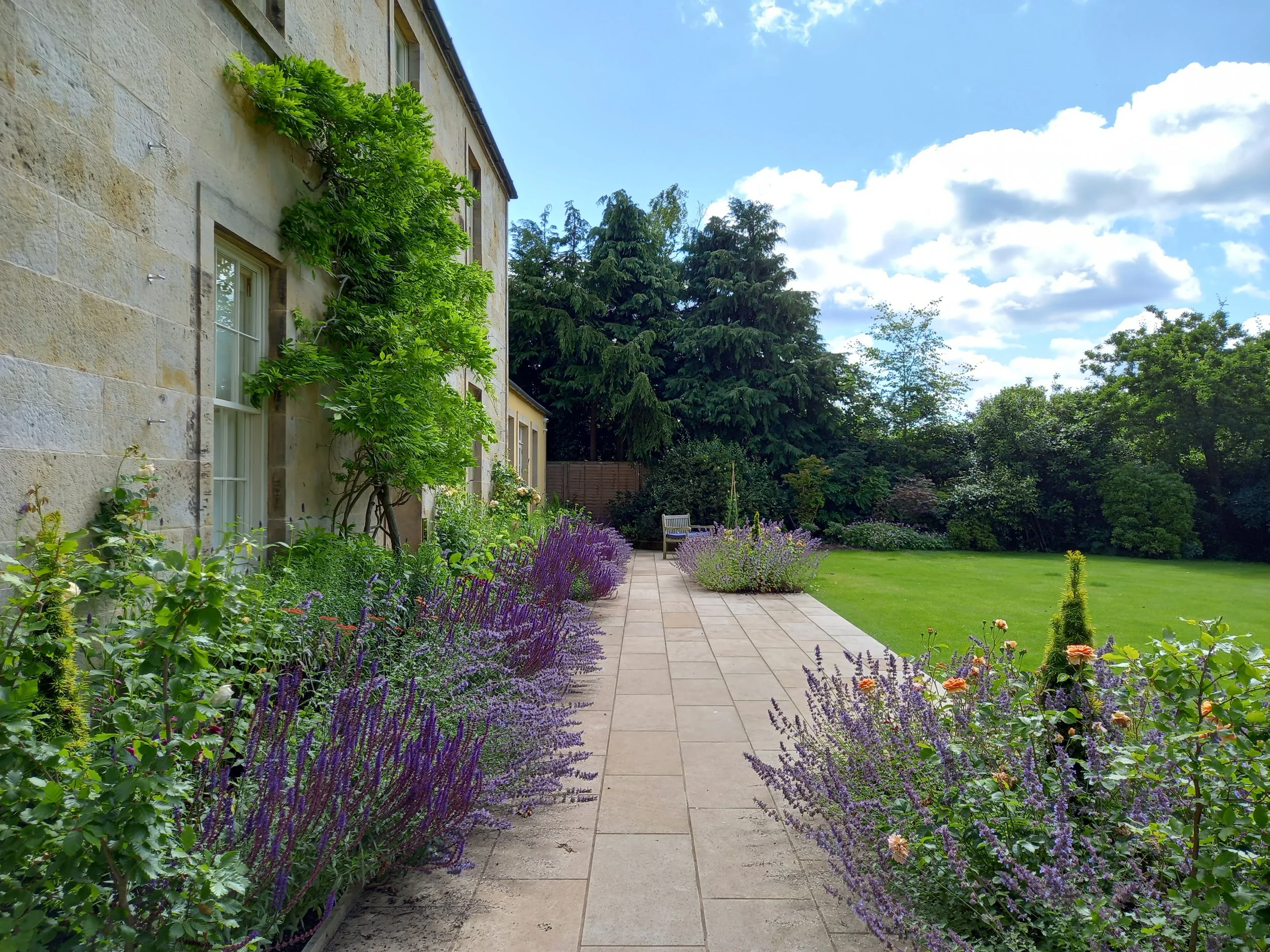 Country house with planting all along the front.