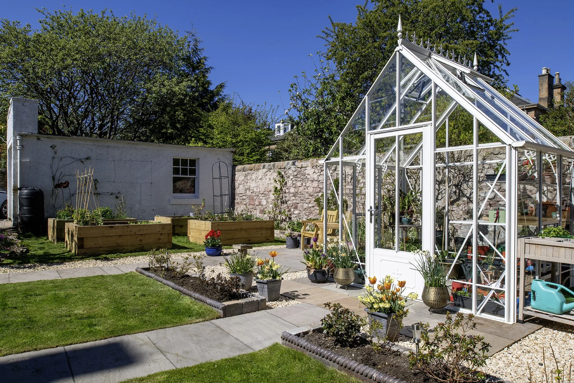 Beautifully laid out kitchen garden with a heritage glasshouse.