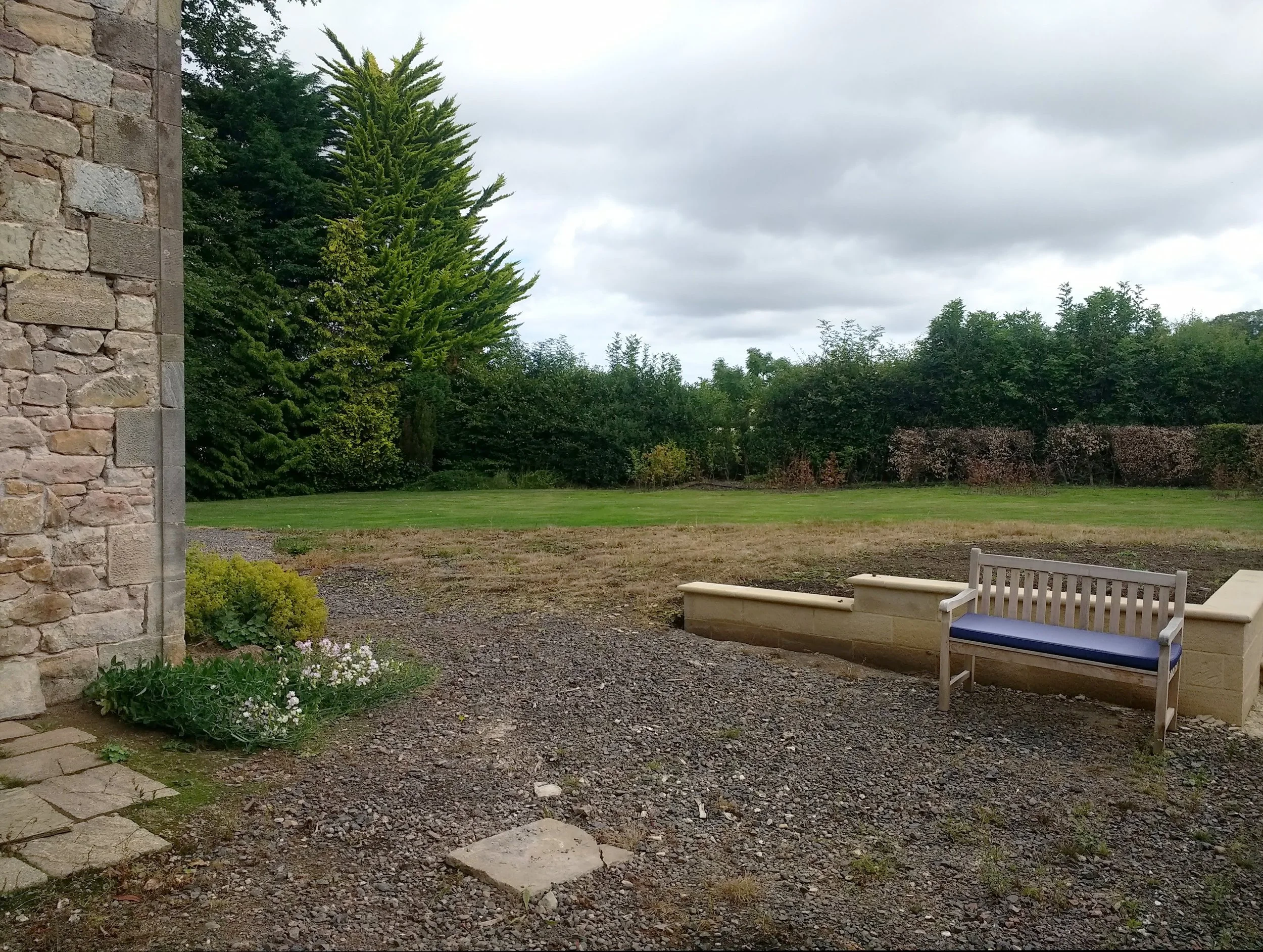 Bare soil around some new terrace walls.