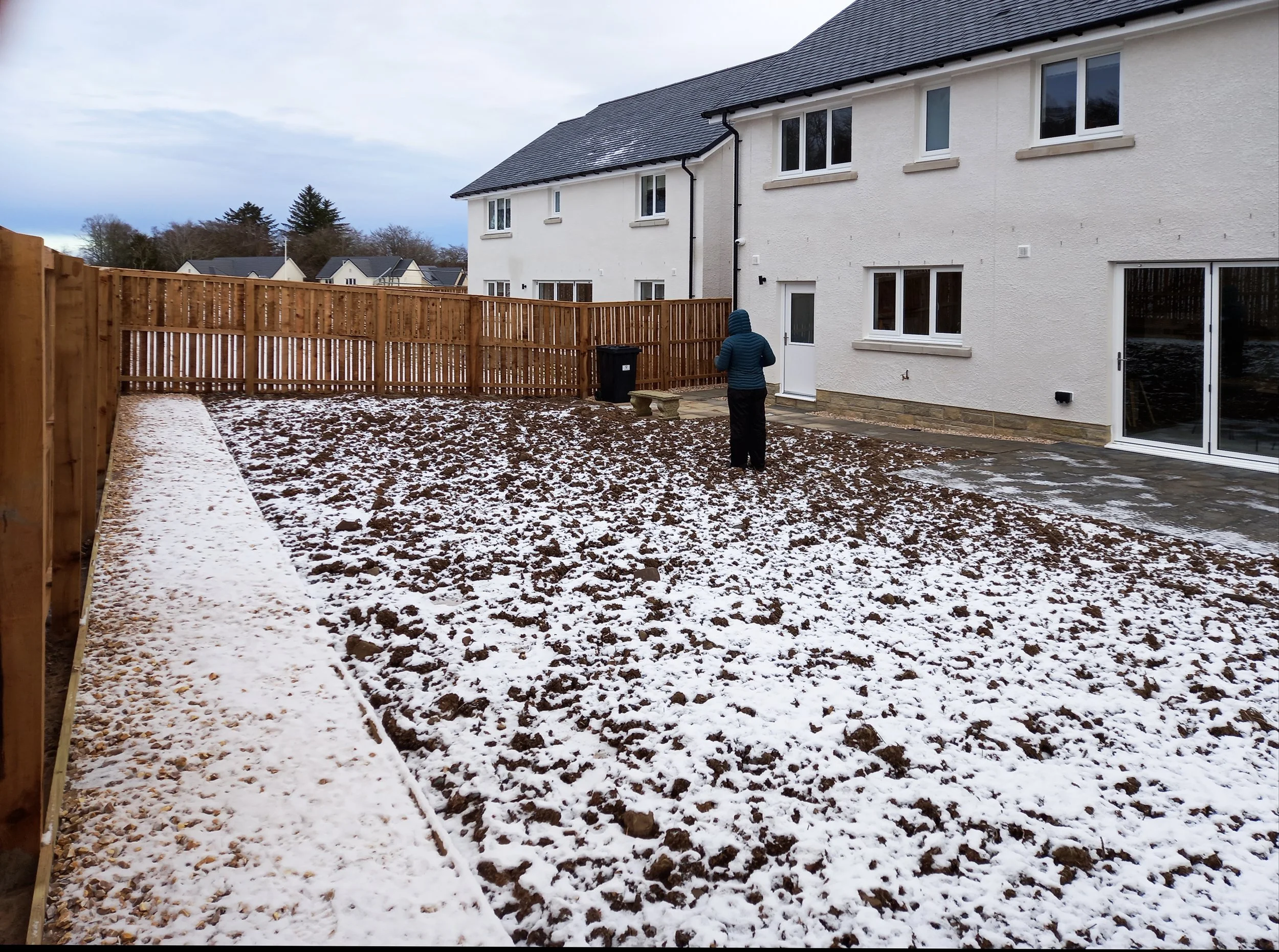 A bare outdoor space, covered in snow.