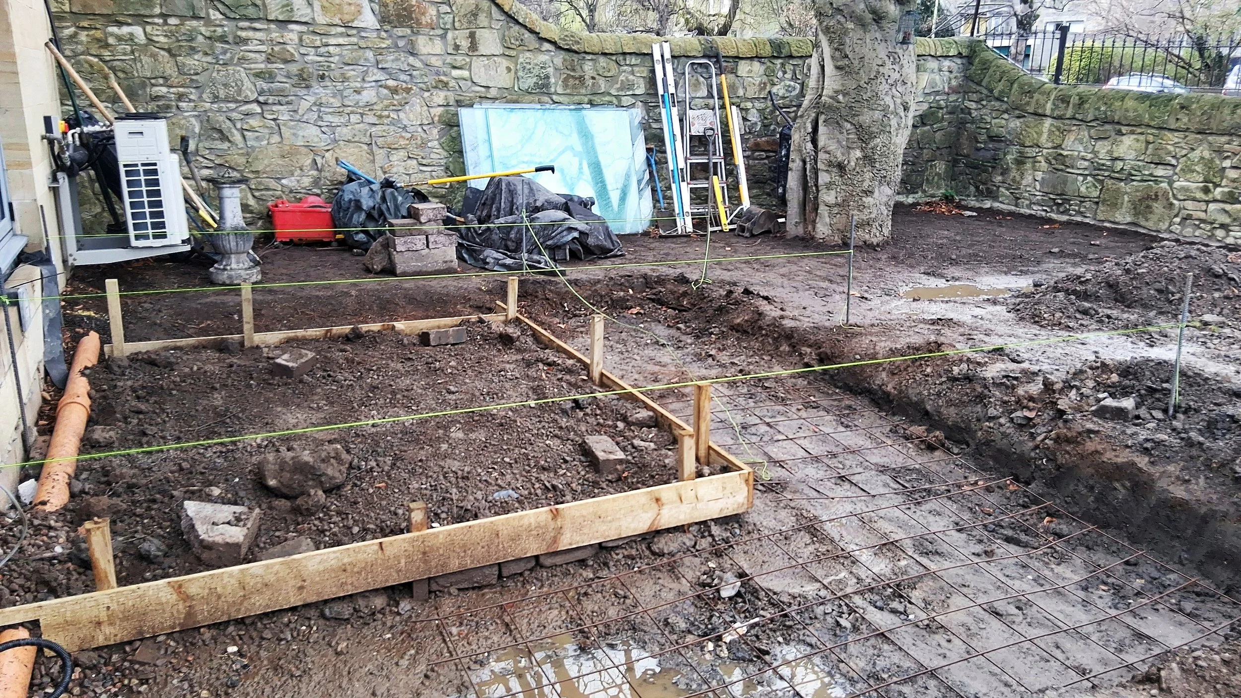 The building of a patio, and a garden completely dug up.