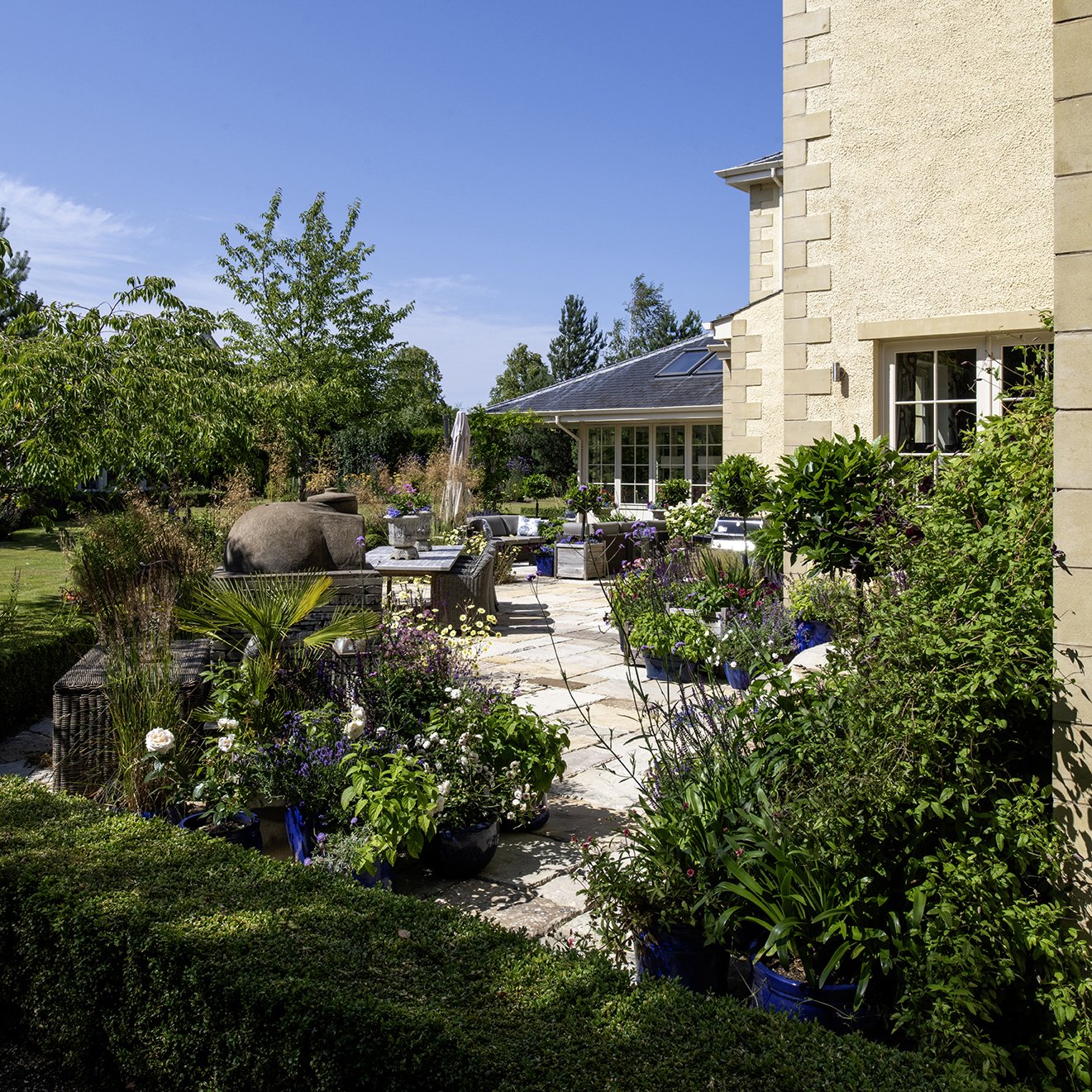 Large sunny terrace with lots of planters