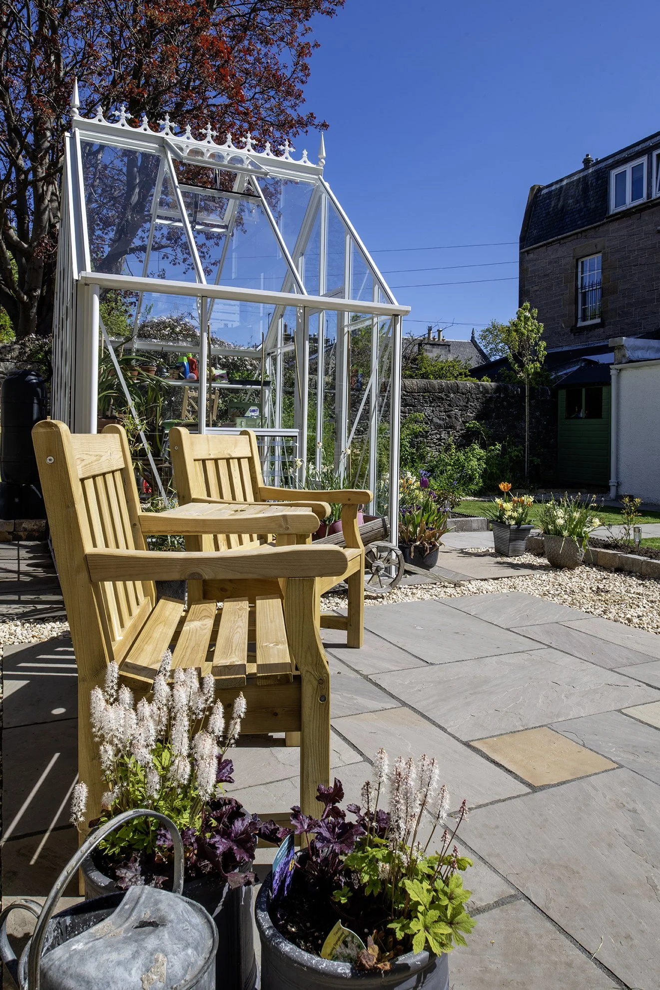 A seating area looking towards a beautiful heritage glasshouse, Edinburgh.