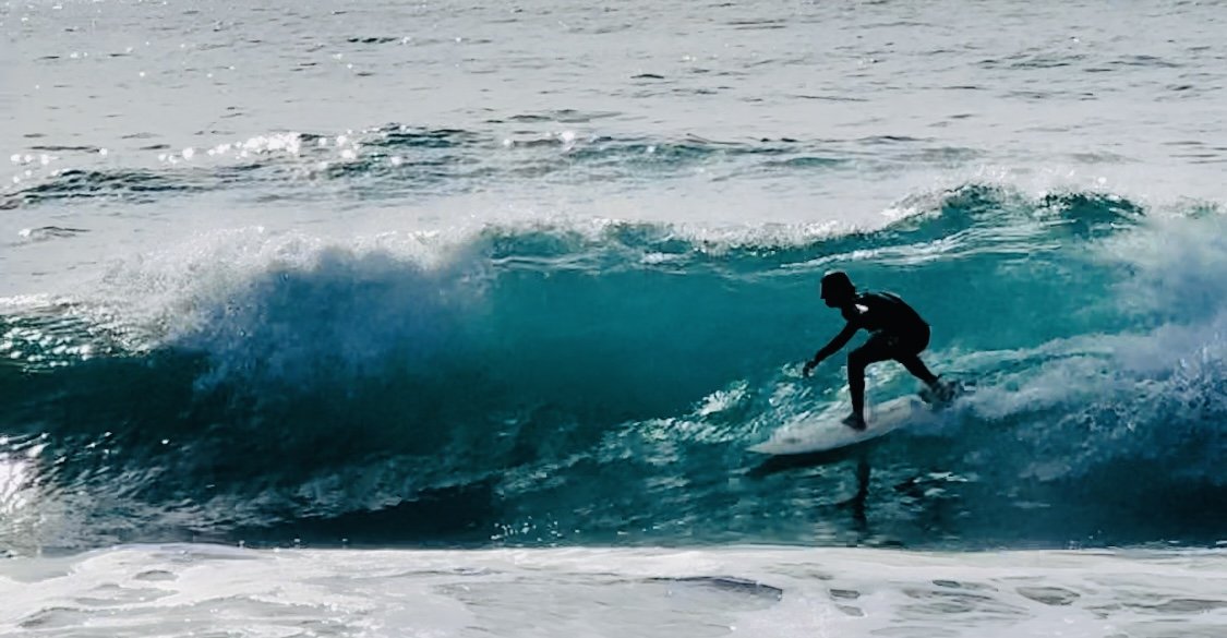 Surfer riding a wave on the ocean