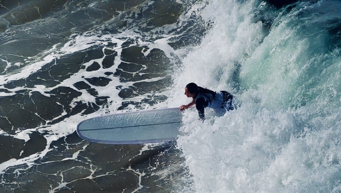 Surfer riding a wave in the ocean
