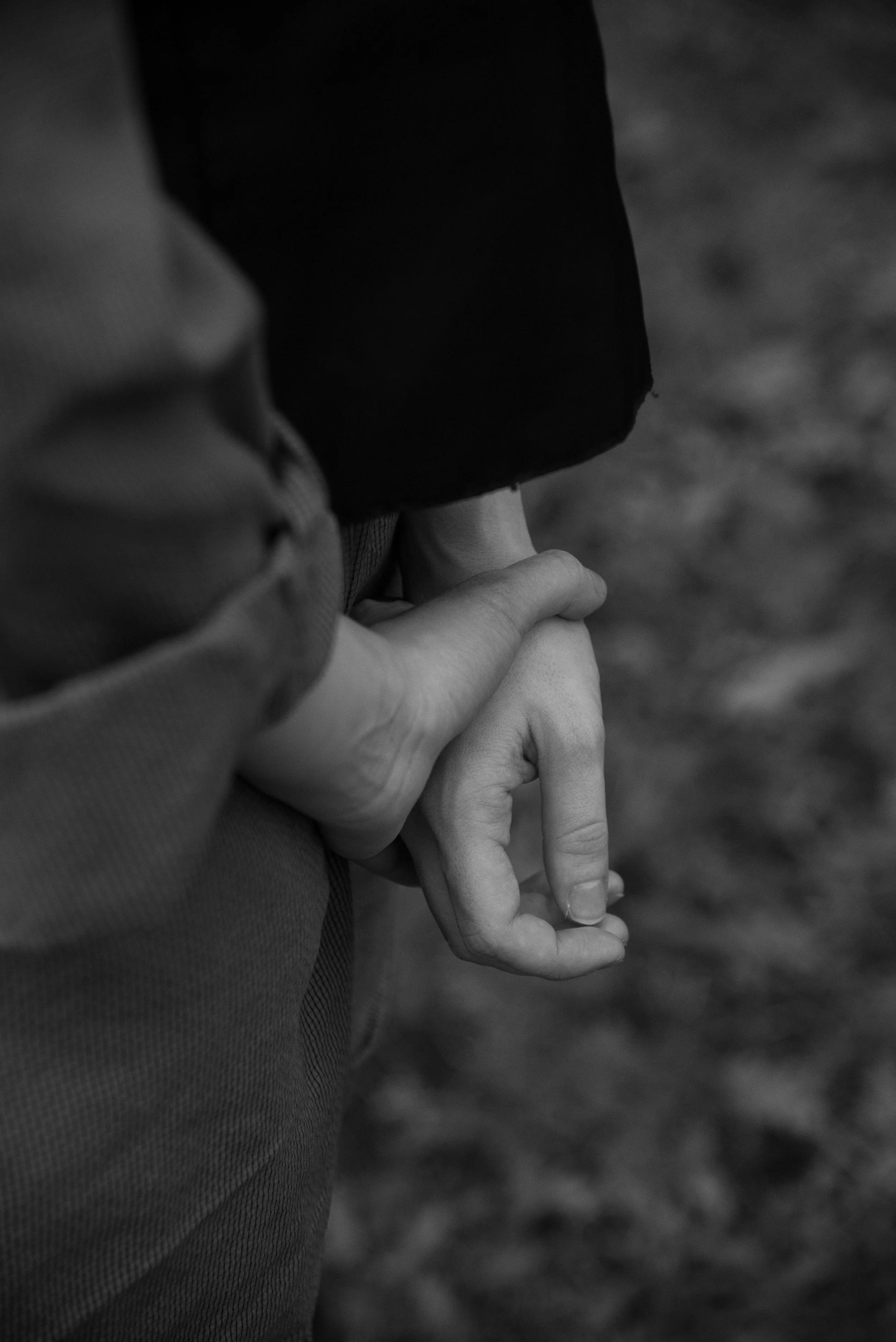 Hands crossed behind their back.