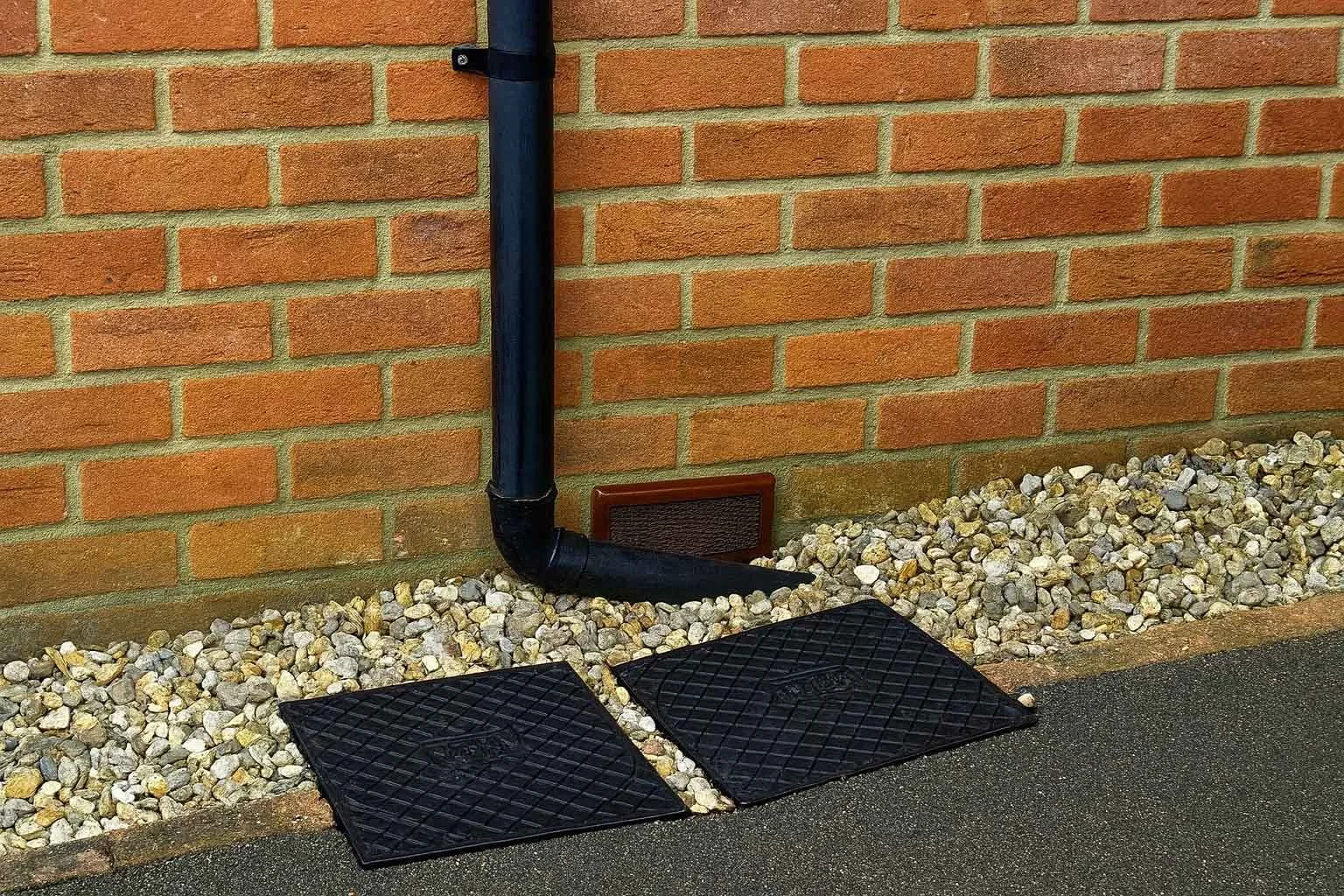 Rat proofing air brick cover (preventavent)and drainpipe outside Essex home with covers over drain access points