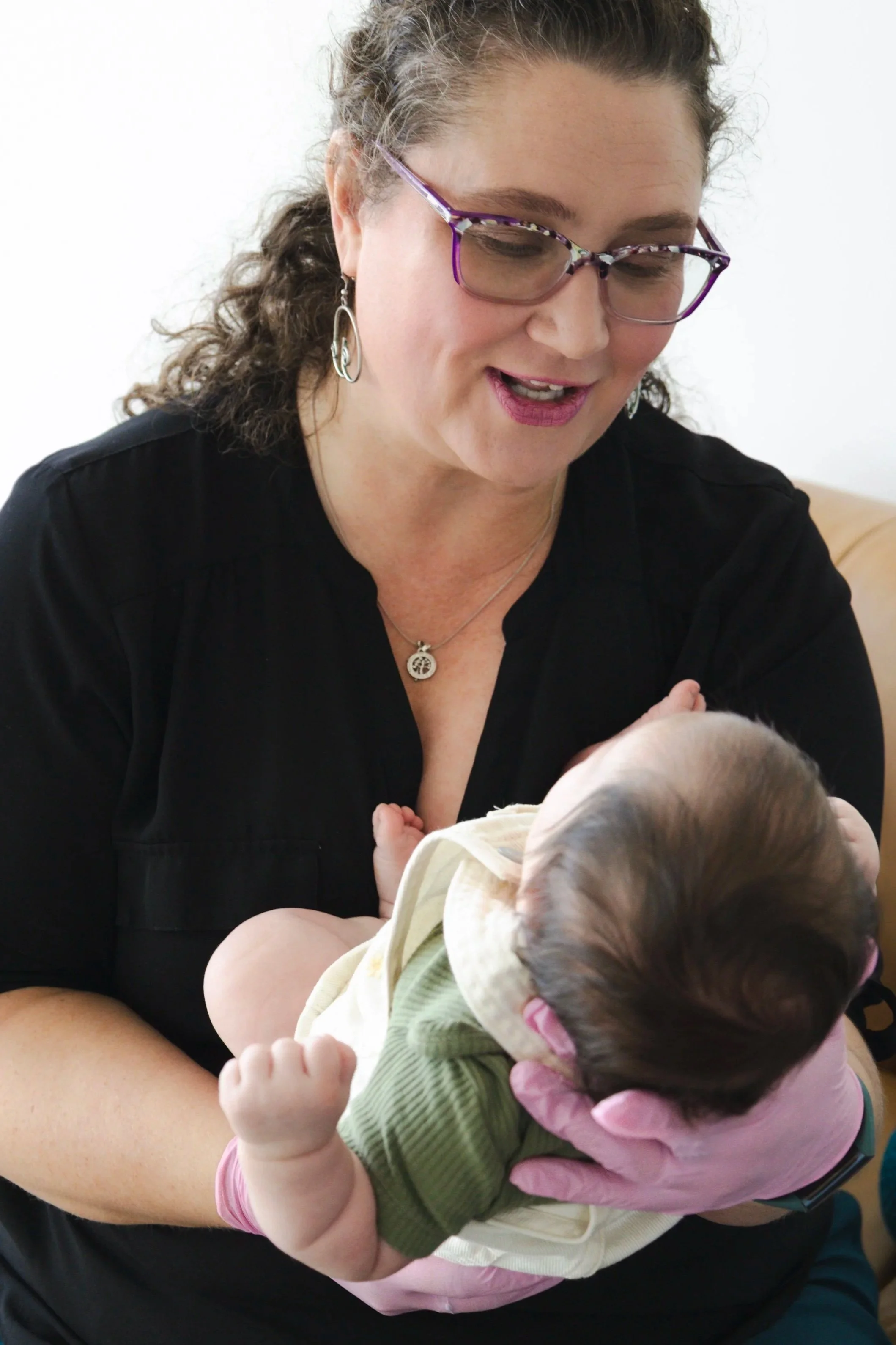 Heather Martin, IBCLC, CEIM speaking softly and smiling with a young infant