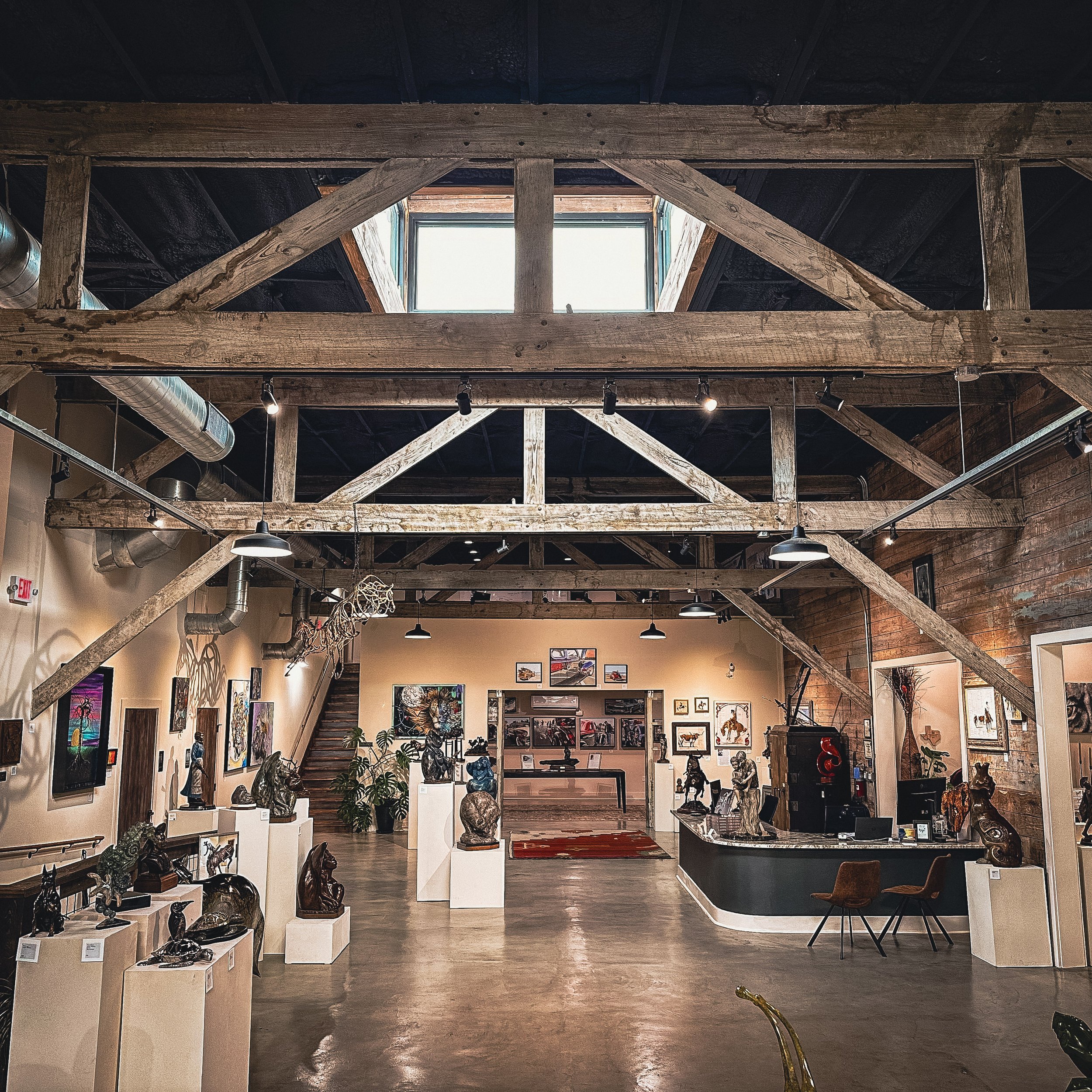 These original wooden trusses from the 1800s are structural as well as aesthetically pleasing to the eye as the provide a symmetrical feel to the space. Modern elements such as lighting and ductwork all tie into the overall feel of the showroom.