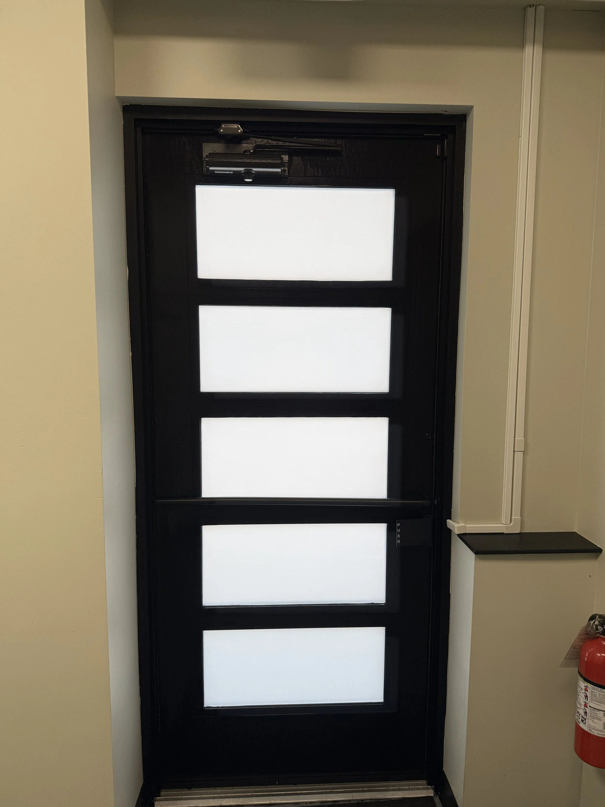 Window tint installed on a door by Fine Line Auto Wraps in Holland, MI.