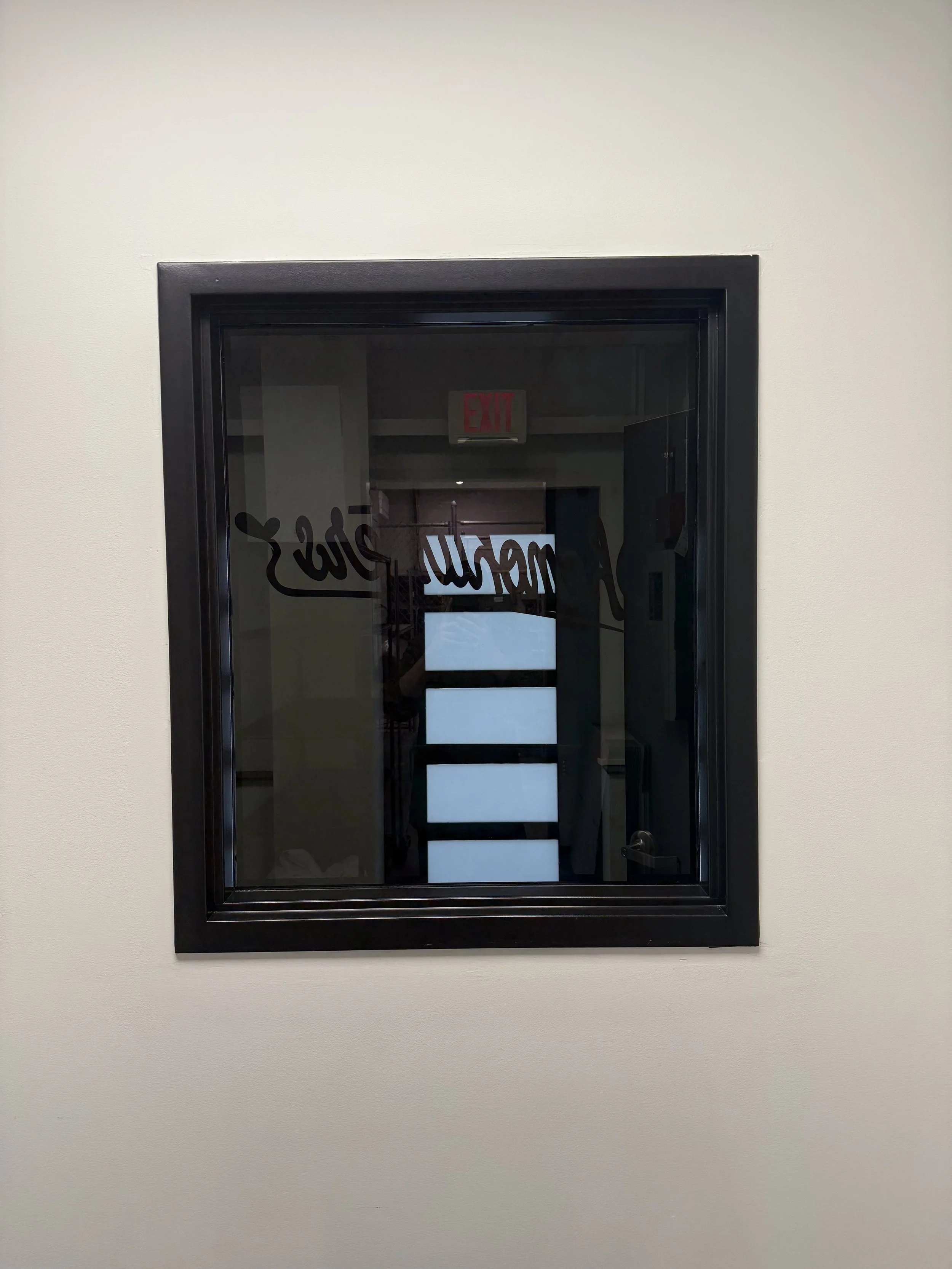 Window tint installed on a window by Fine Line Auto Wraps in Holland, MI.