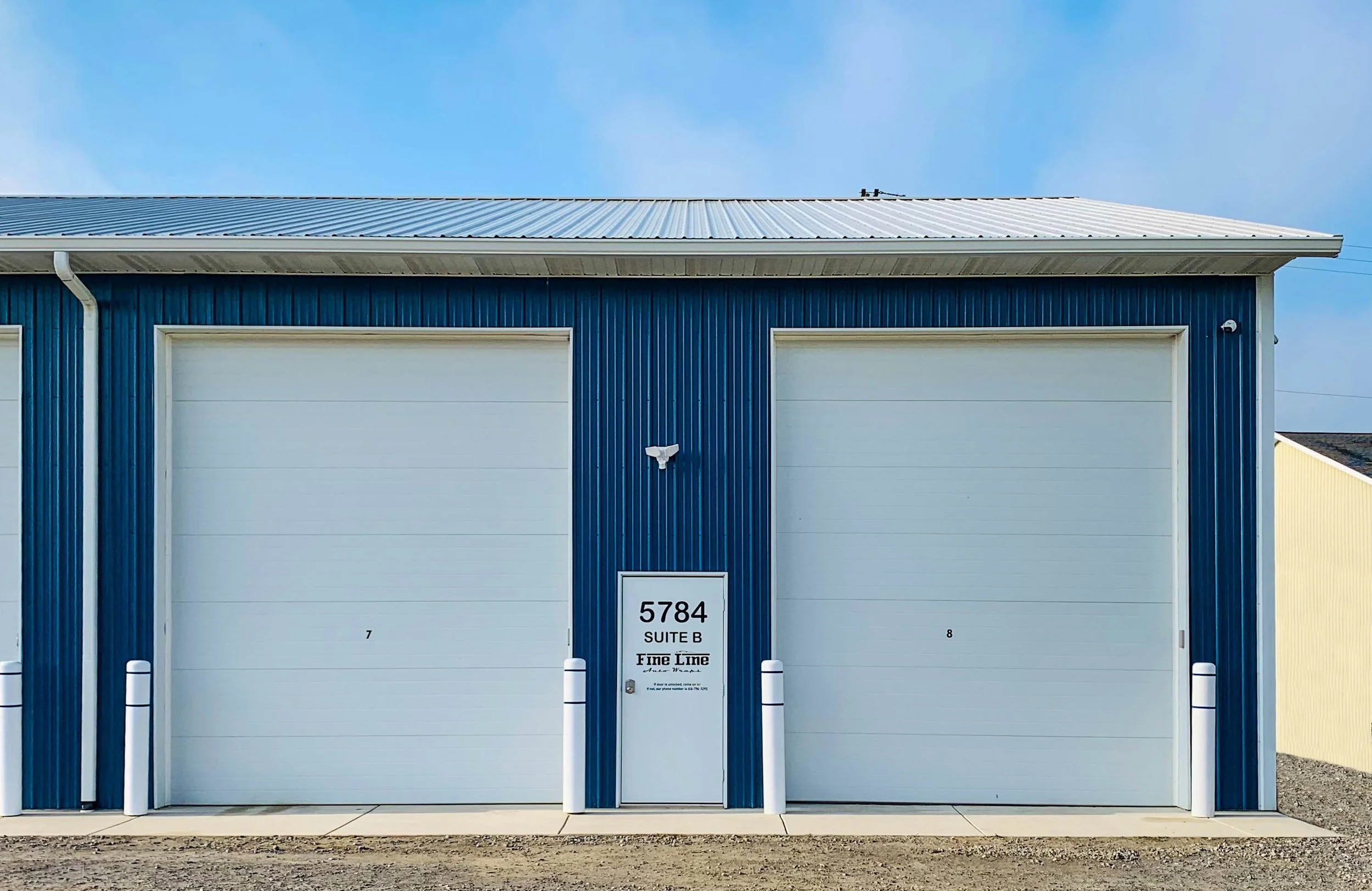 Fine Line Auto Wraps is housed in a large blue metal building.