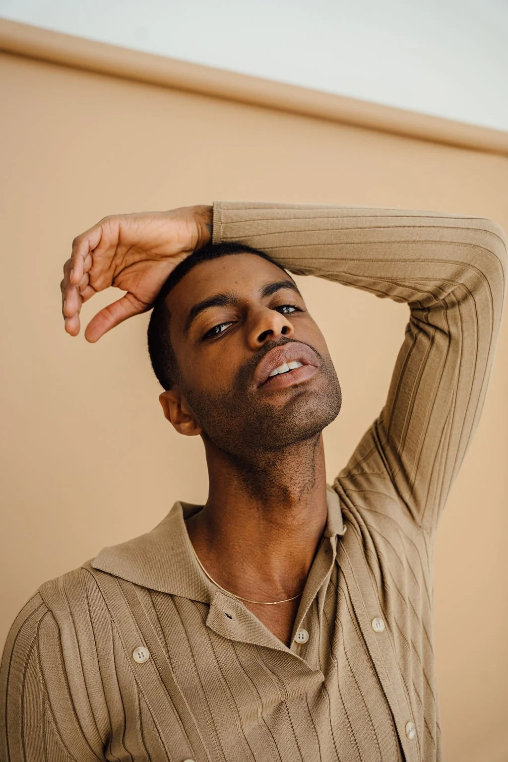 Patrick Sims in a high fashion editorial featuring tailored menswear.