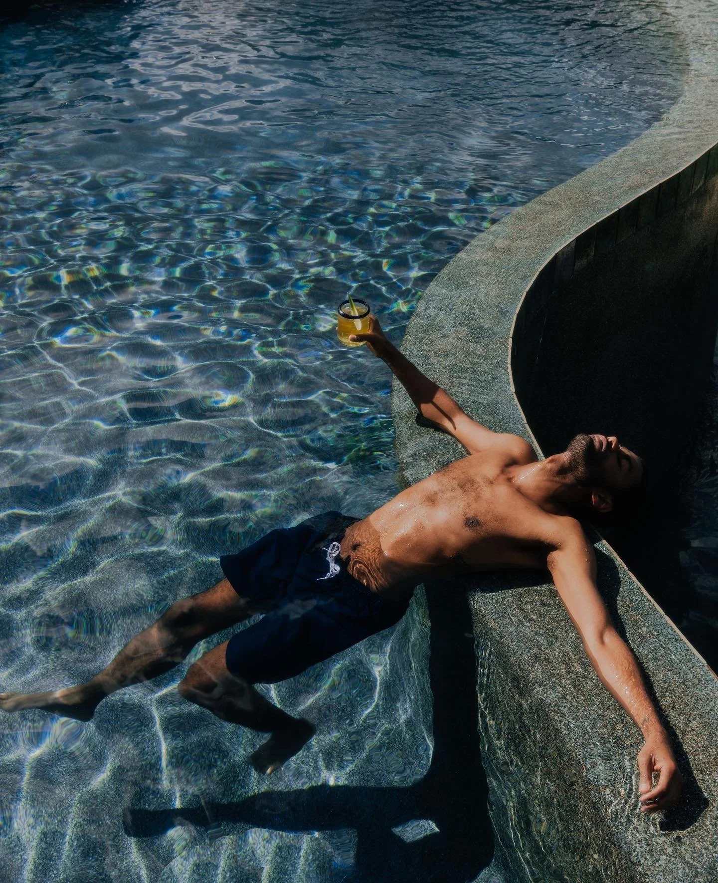 Patrick Sims relaxing poolside for Mayawell.