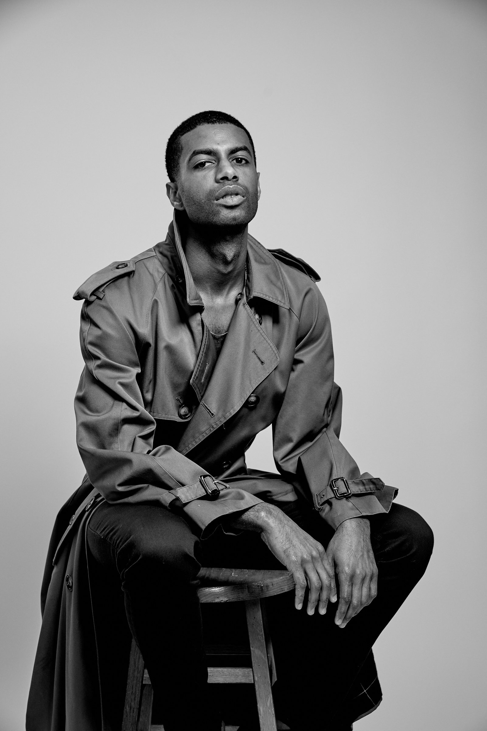 Portrait of Patrick Sims wearing a vintage trench coat.