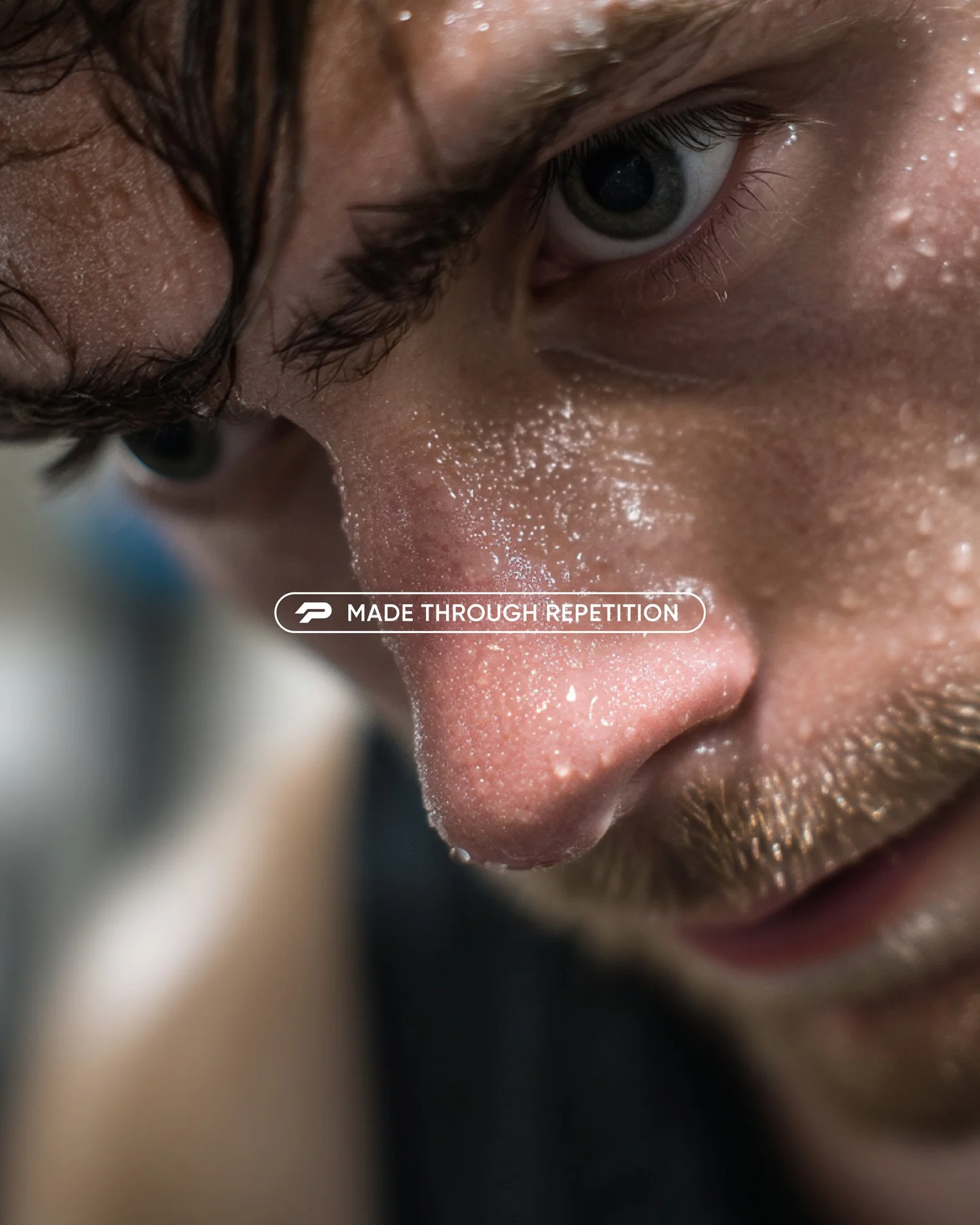 Intimate performance-focused brand imagery for Pure Strength featuring a close-up of an athlete in exertion, reinforcing the message “Made through repetition” and the discipline behind strength training.