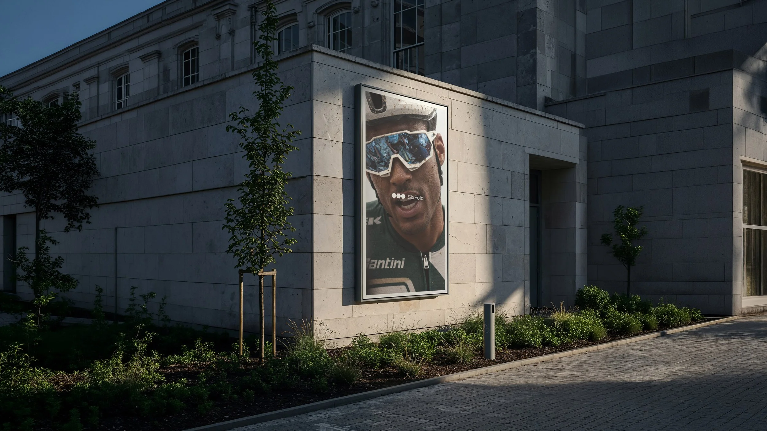 Sixfold brand identity design applied to large-scale outdoor advertising, featuring athletic portrait photography of a cyclist on an architectural billboard.