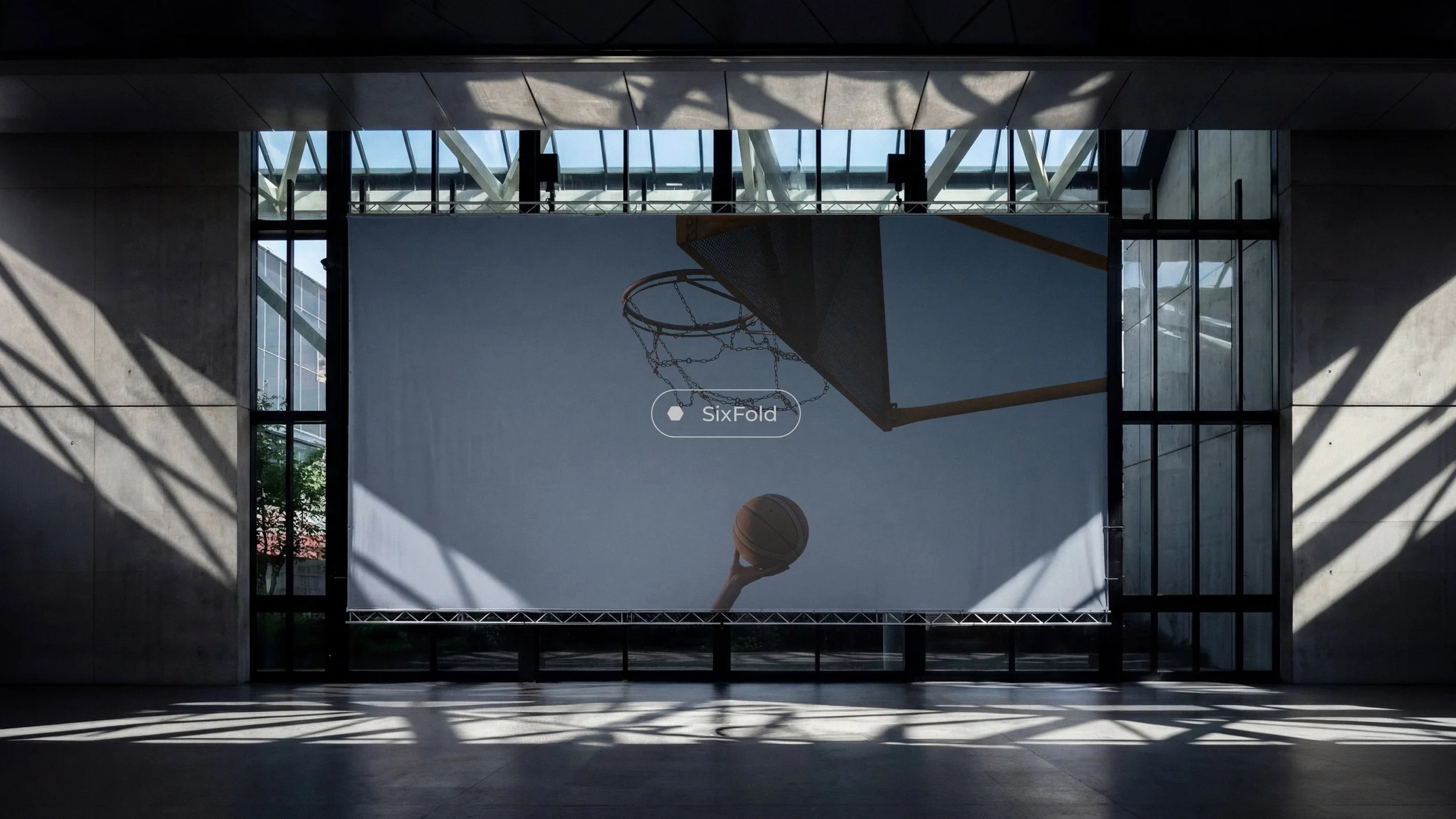 Sixfold sports branding and visual identity showcased through a contemporary indoor basketball court with architectural photography.
