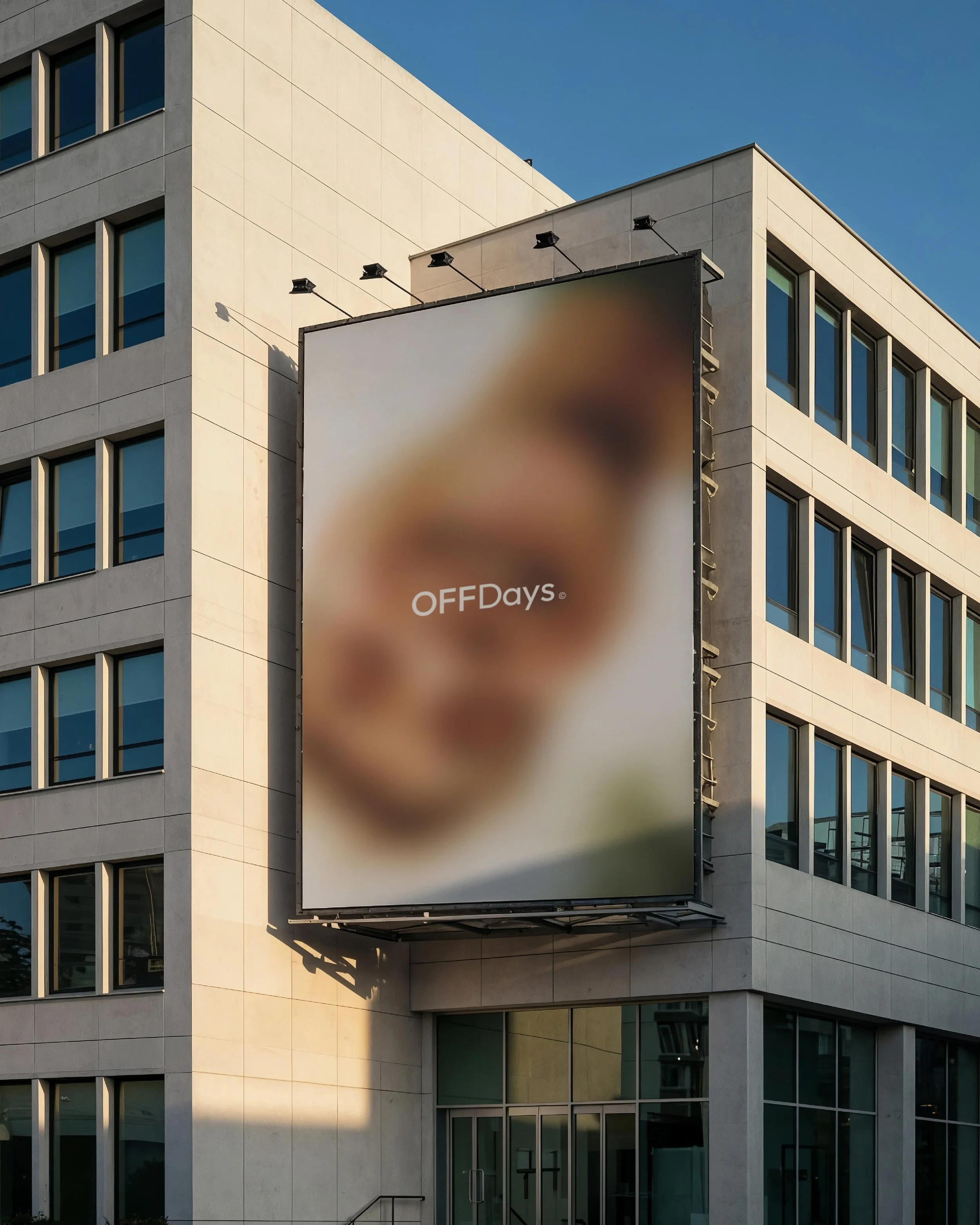 OFFDays lifestyle brand identity displayed on a large outdoor billboard, featuring a minimal typography-led wordmark and blurred imagery. The restrained art direction highlights mood, distance and calm, contemporary branding.