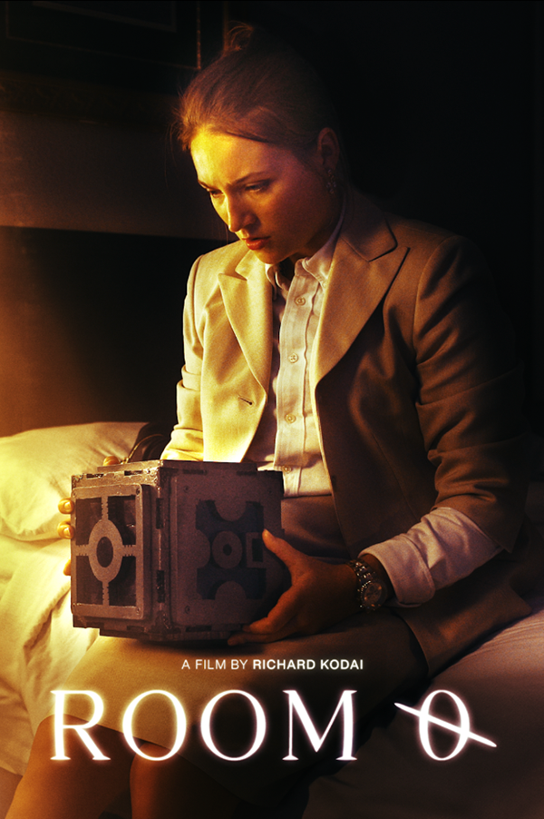 A person in a formal suit sitting on a bed, holding a mysterious-looking cube with geometric patterns. The image is a promotional poster for a film titled 'Room 0' by Richard Kodai, with warm lighting creating a contemplative atmosphere.