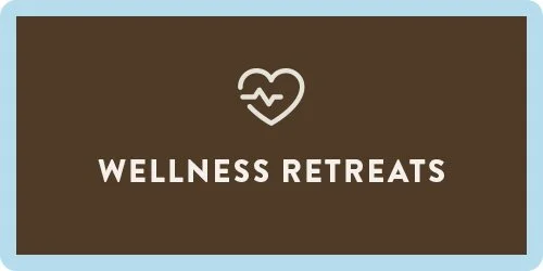 Brown background with white heart and heartbeat line symbol above the words 'Wellness Retreats' in white text.