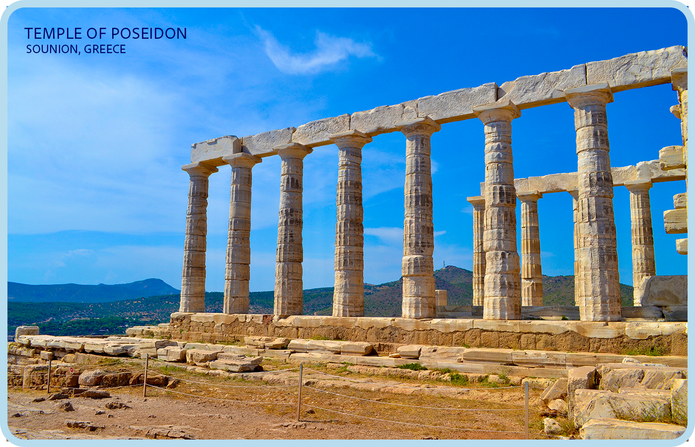 Ancient Greek temple ruins with tall stone columns at the Temple of Poseidon in Sounion, Greece, under a bright blue sky with some clouds.