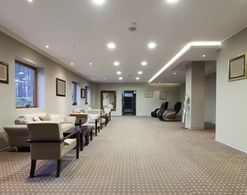 Spacious indoor common area with recessed lighting and seating, ideal for showcasing HVAC systems designed for multi-tenant or commercial building shared spaces.