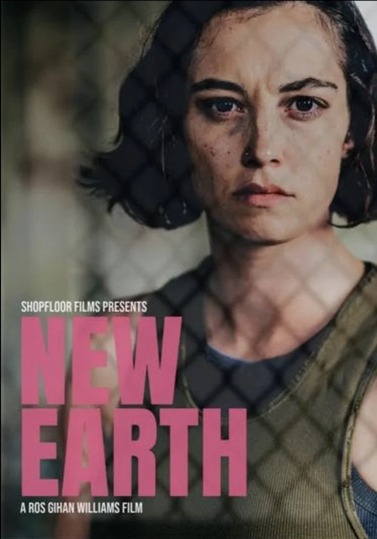A woman with short dark hair, dirty face, and serious expression, wearing a camouflage tank top, in a post-apocalyptic or dystopian setting.