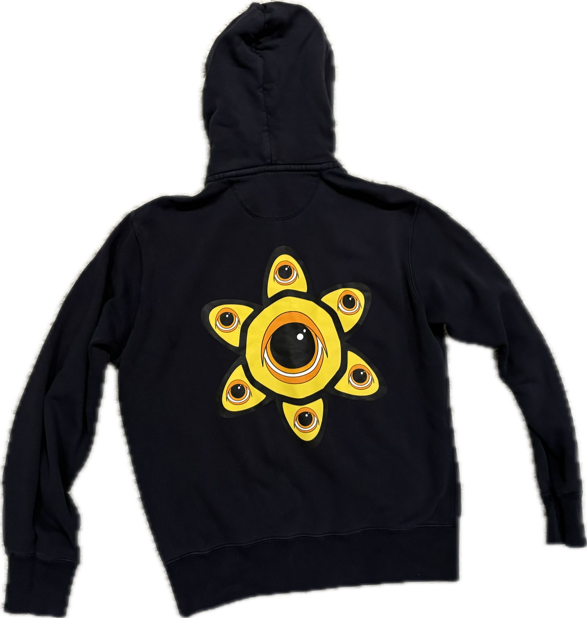Hand-drawn sketch sheet showing the eye-in-flower design repeated a few times in pencil/pen, photographed flat. Sits alongside the finished versions of the same design on the hoodie and YETI bottle in the two photos next to it on the page.