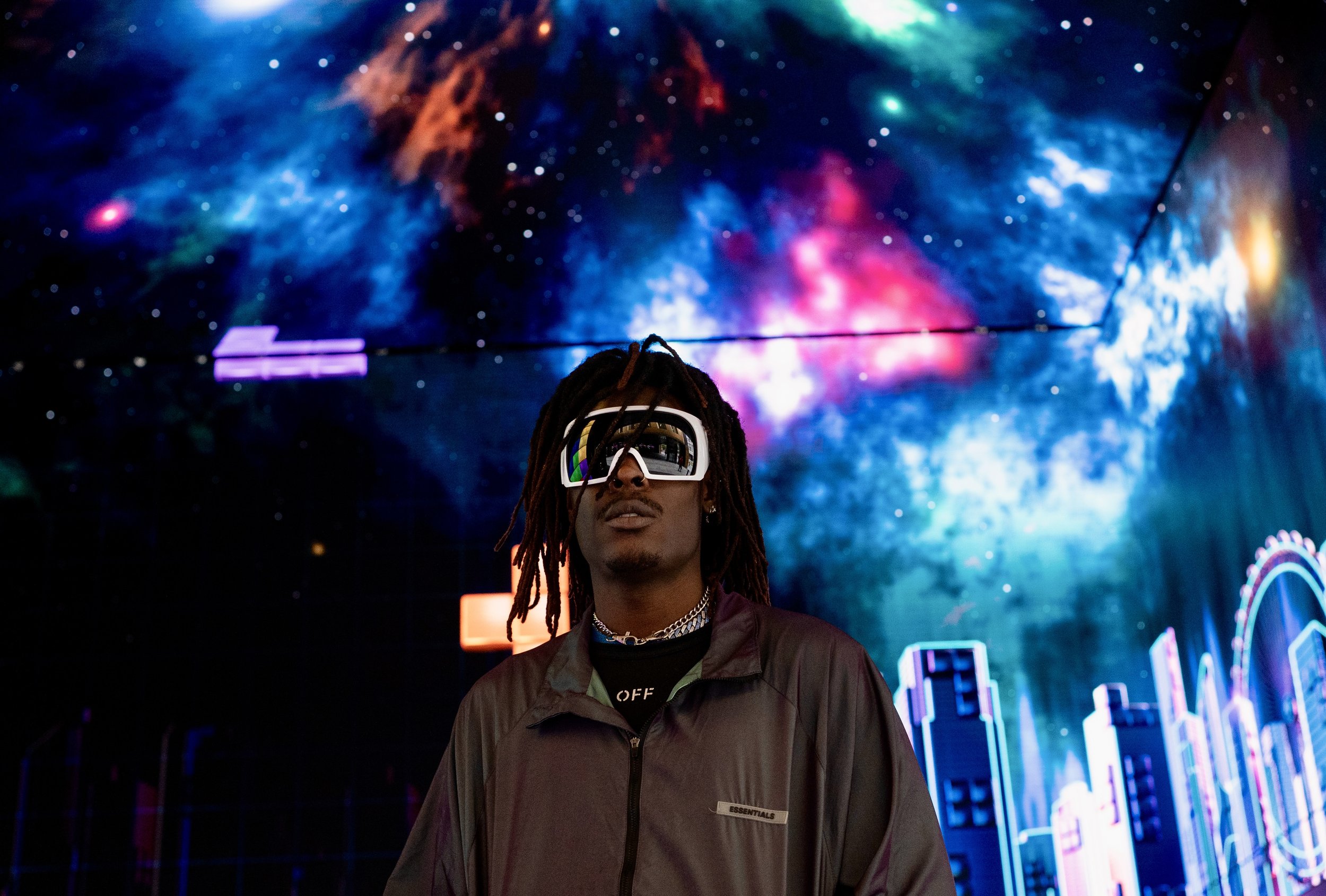 Shot of Musical Artist/Rapper Young Gstar with white goggle style sunglasses in space environment.
