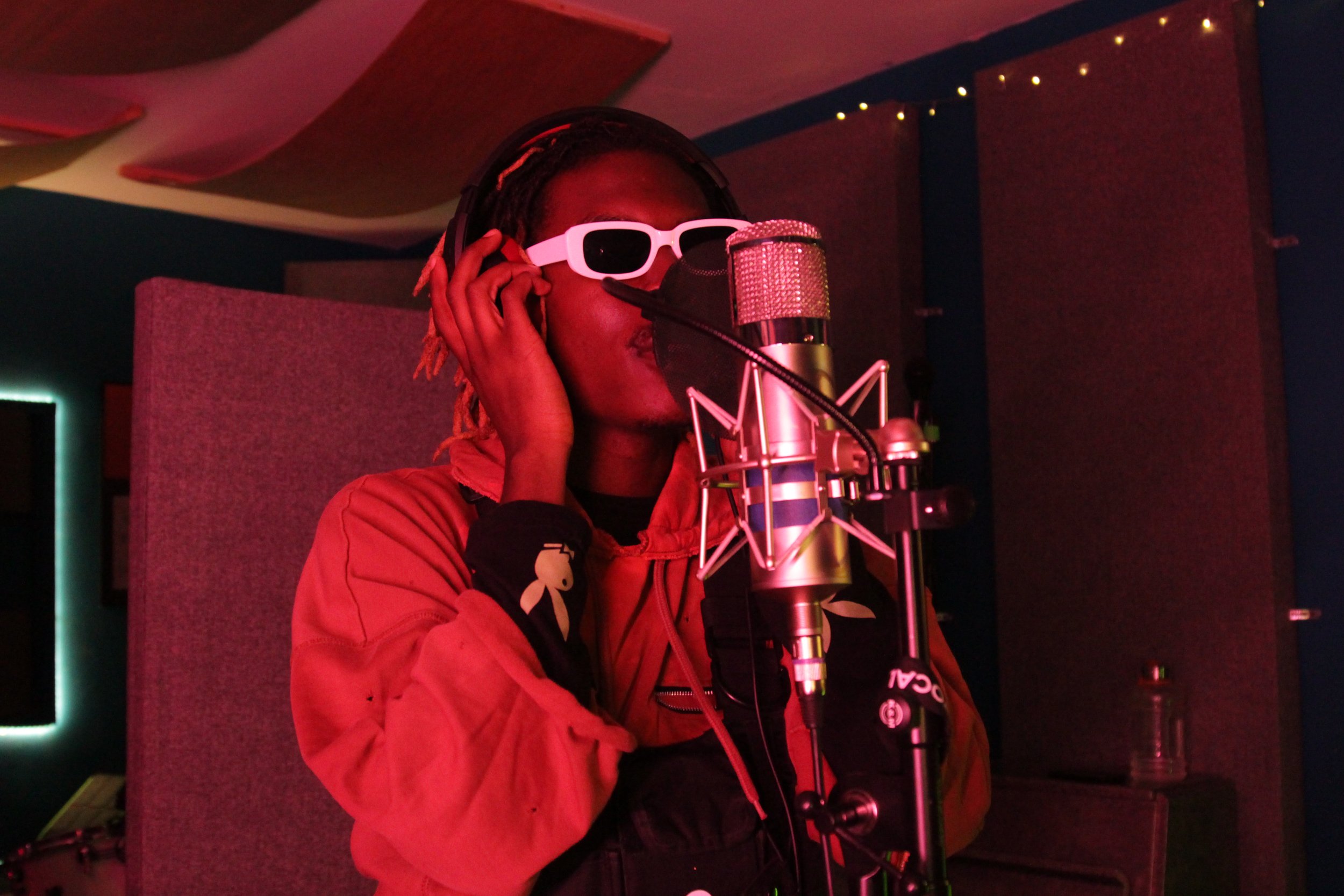 Image of Musical Artist/Rapper Young Gstar on the mic in the studio.