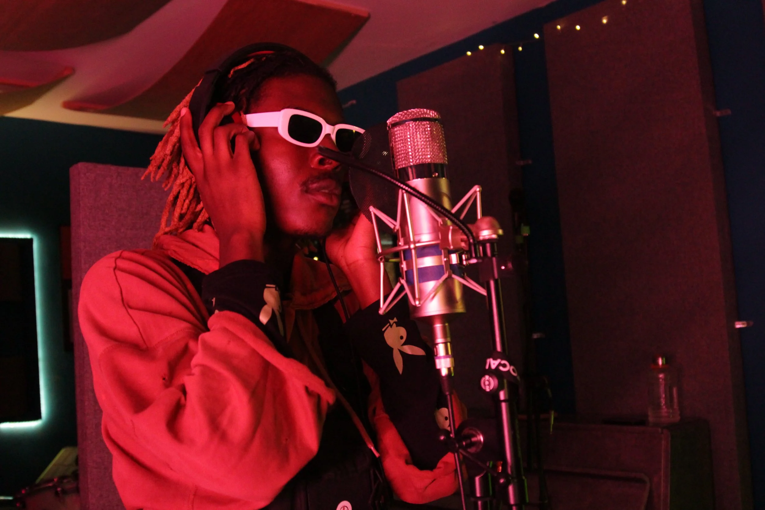 Image of Musical Artist/Rapper Young Gstar on the mic in the studio.