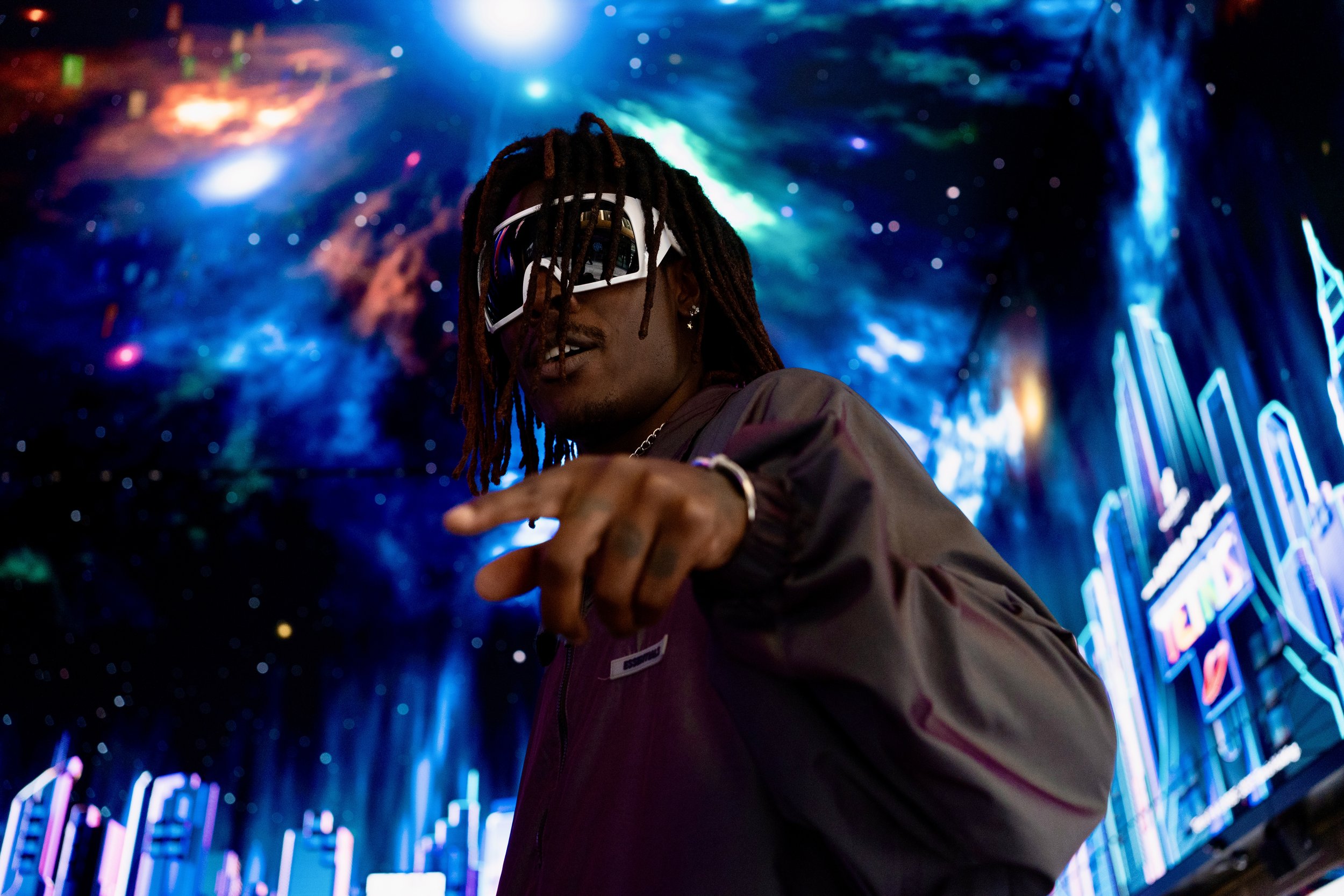 Shot of Musical Artist/Rapper Young Gstar with white goggle style sunglasses in space environment.
