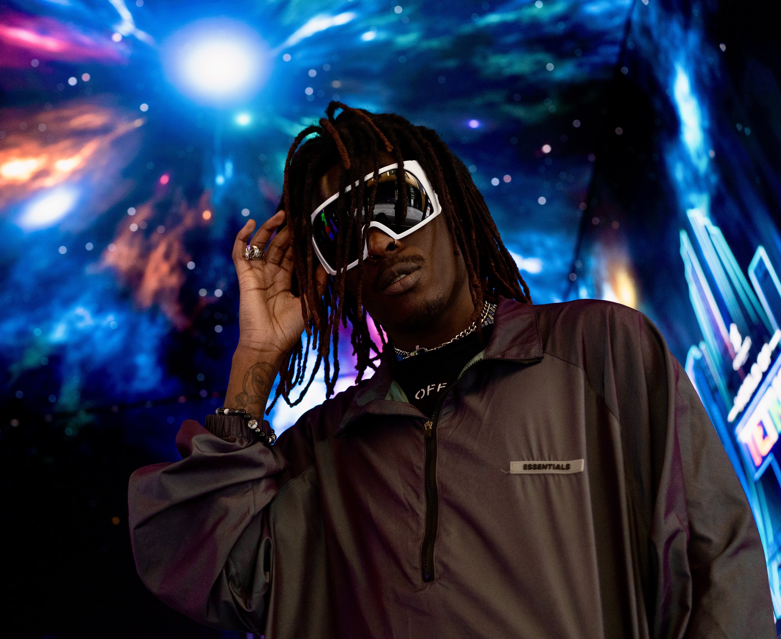 Shot of Musical Artist/Rapper Young Gstar with white goggle style sunglasses in space environment.