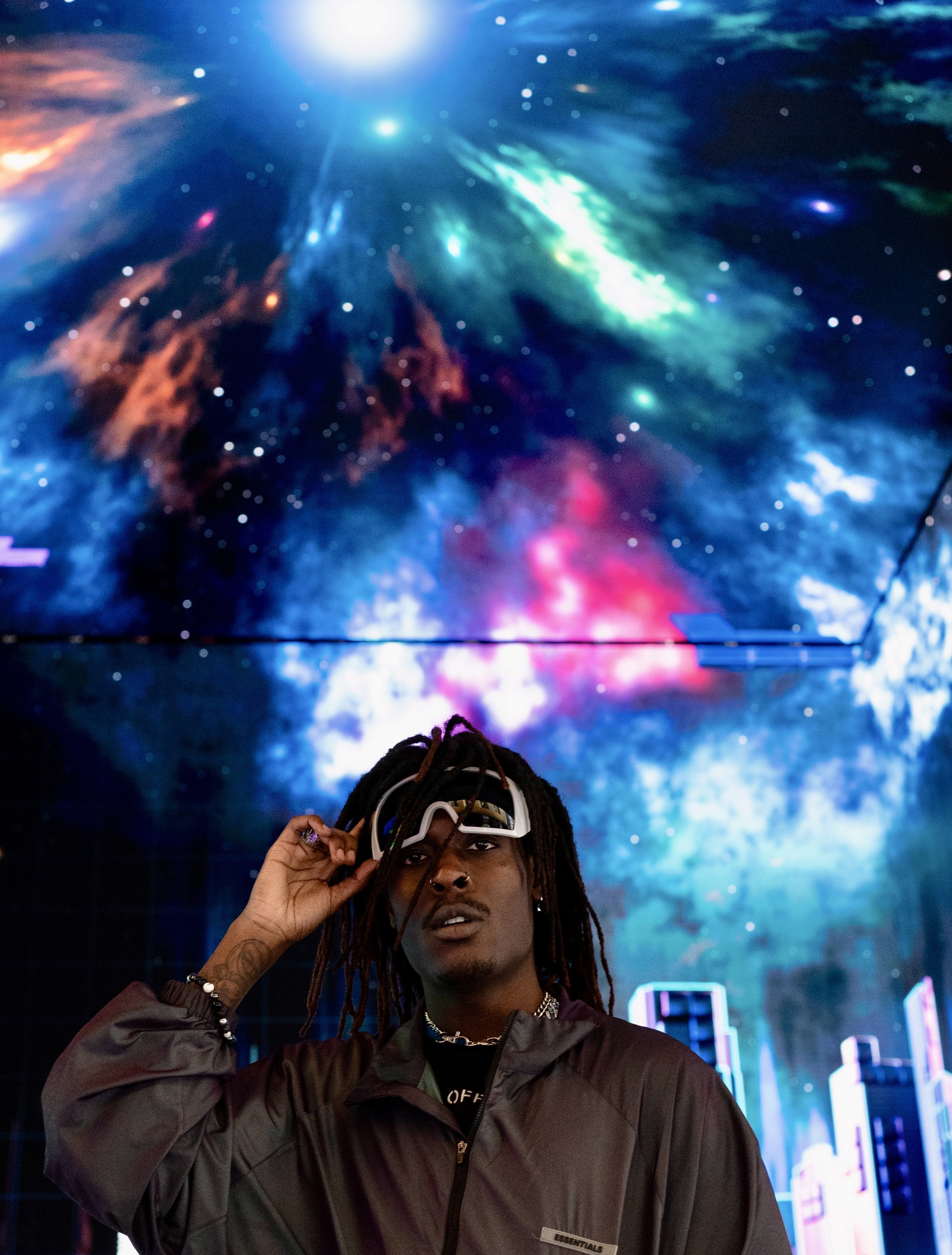 Shot of Musical Artist/Rapper Young Gstar with white goggle style sunglasses in space environment.
