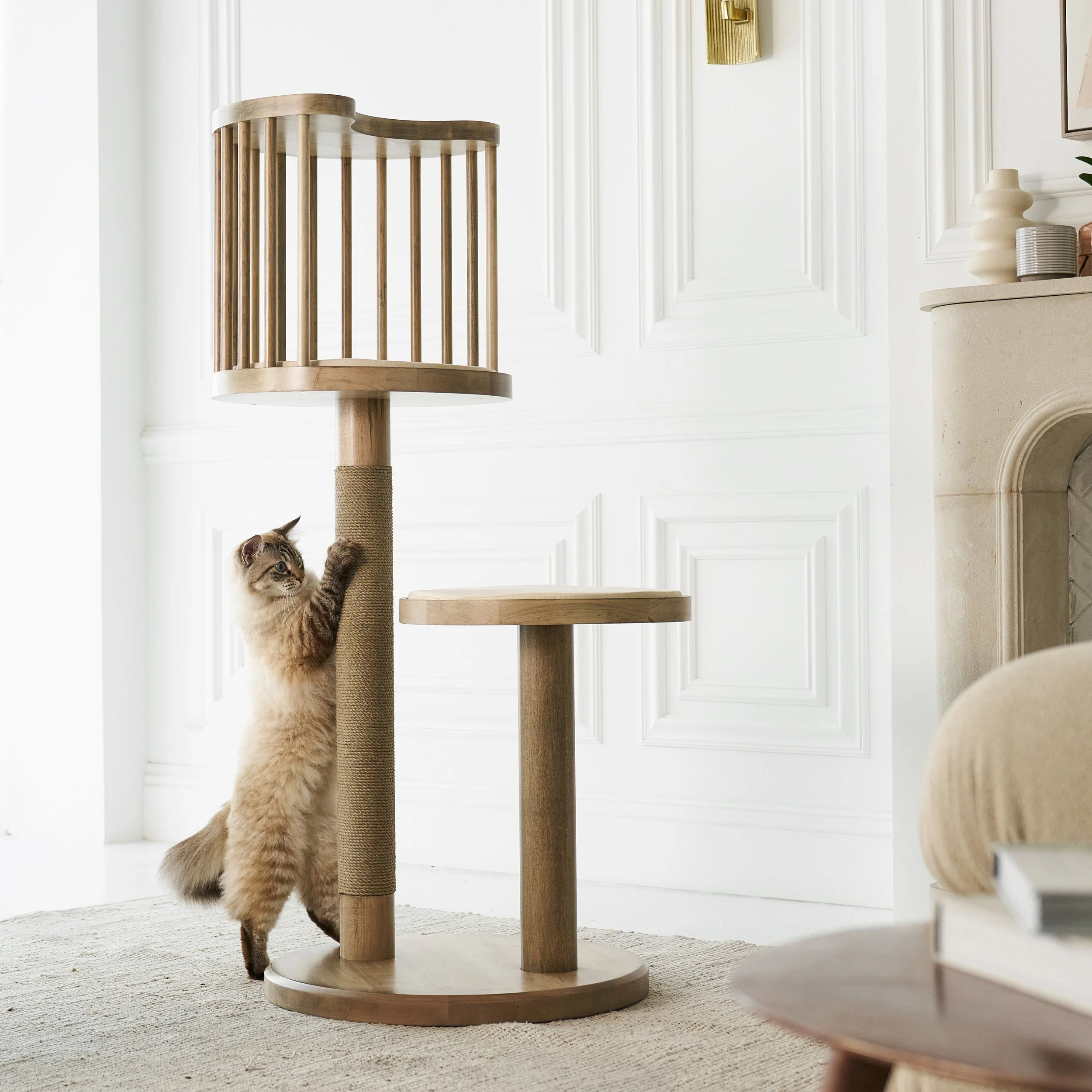 Elegant product photo of a cat tower for Purrsona, set against a warmly lit living room with a cat scratching the post.