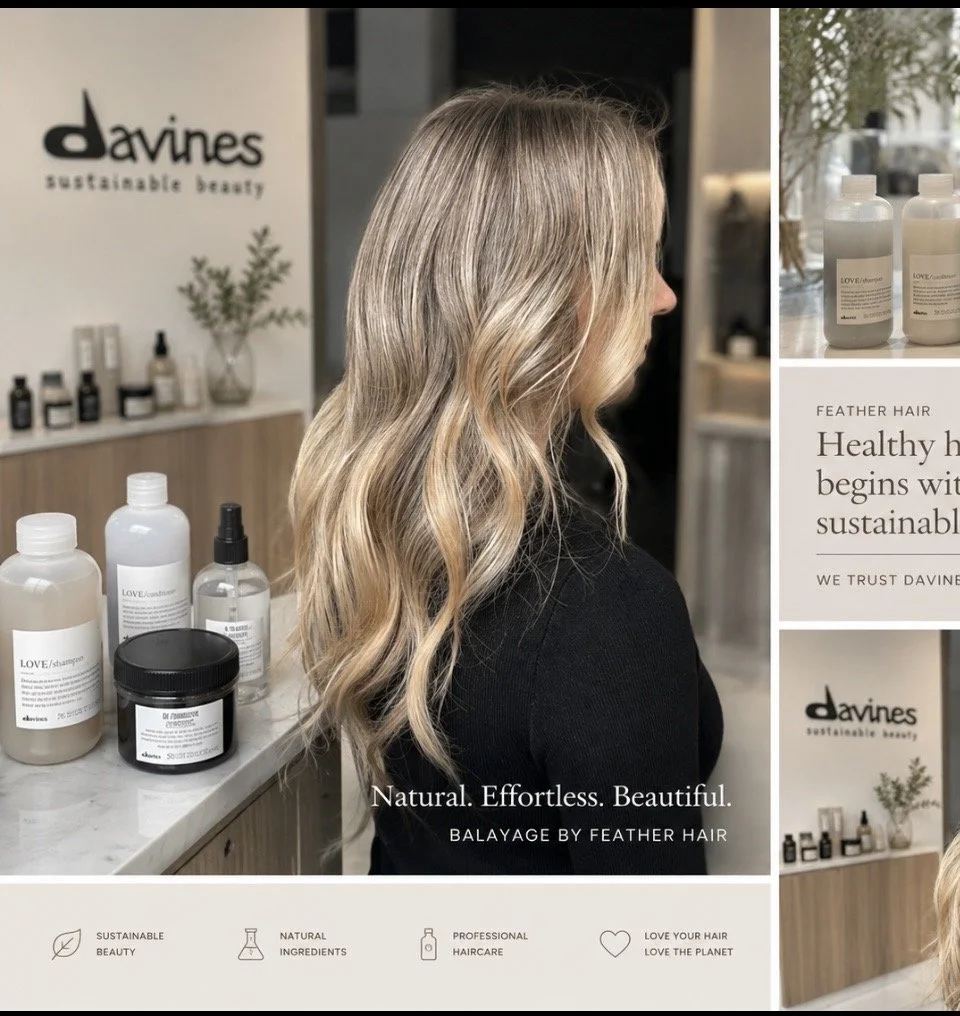 Side view of a woman with long, wavy blonde hair at a hair salon, with hair care products on a marble counter behind her and a Davines sign on the wall.