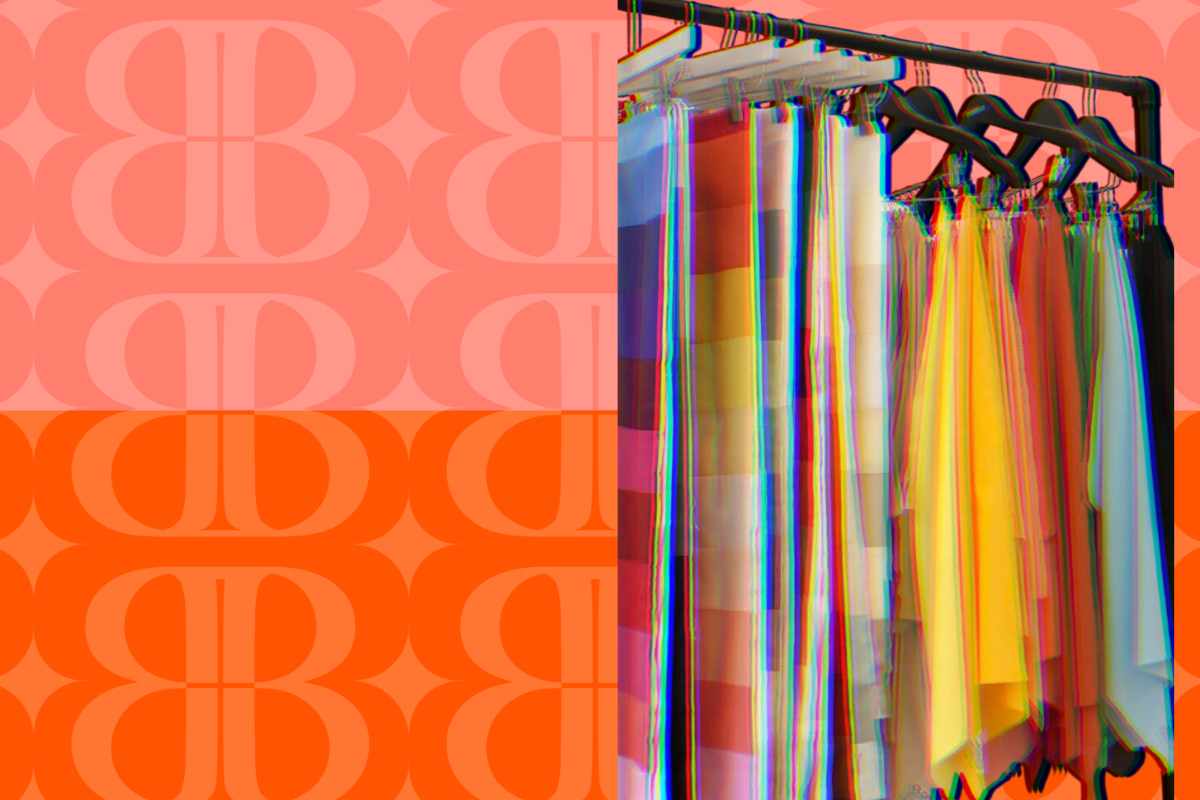 Colorful skirts hanging on a rack against a pink and orange patterned background.