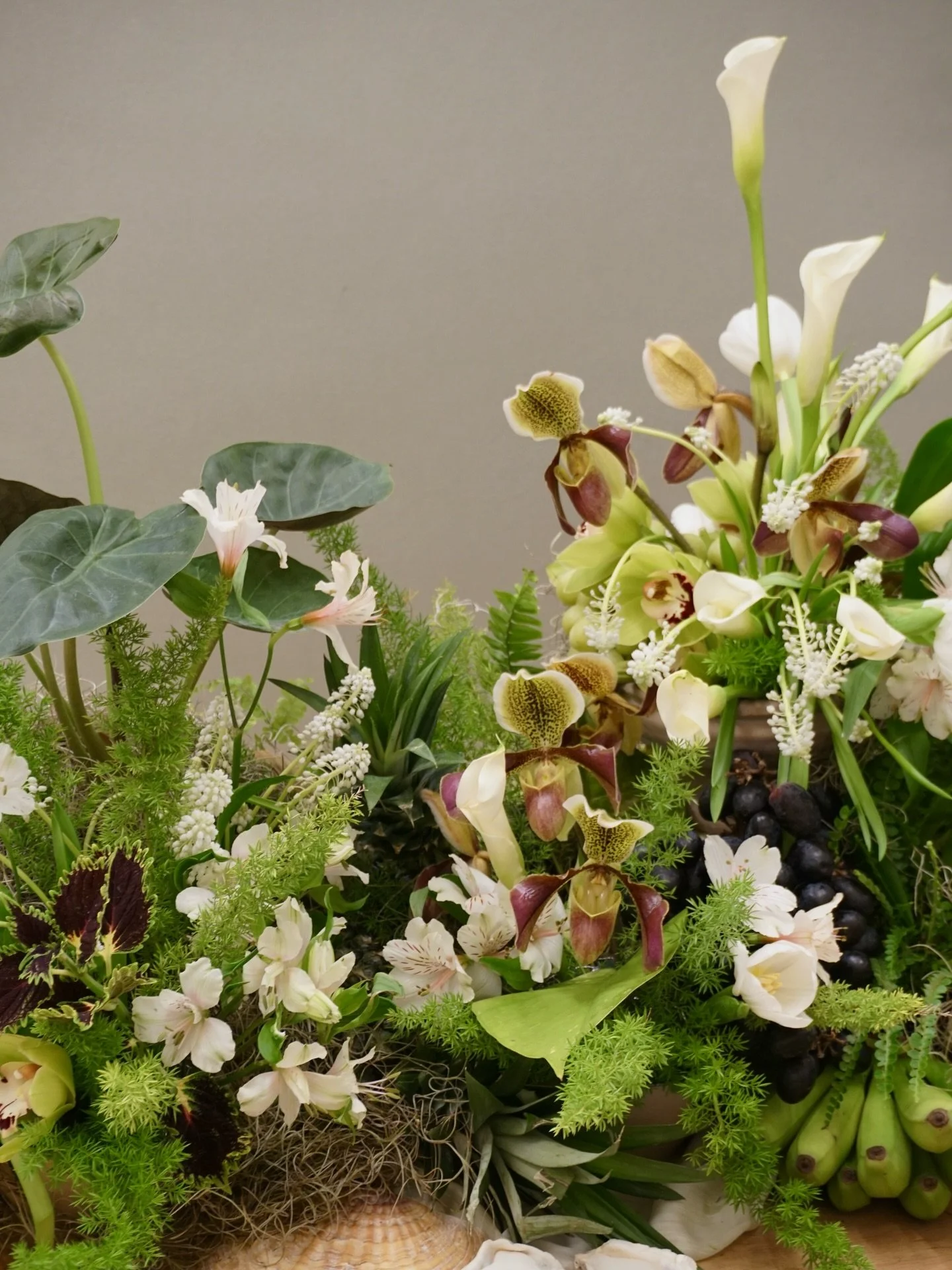 A moody tablescape inspired by the misty rainforests of Southeast Alaska and the tropical beauty of Florida