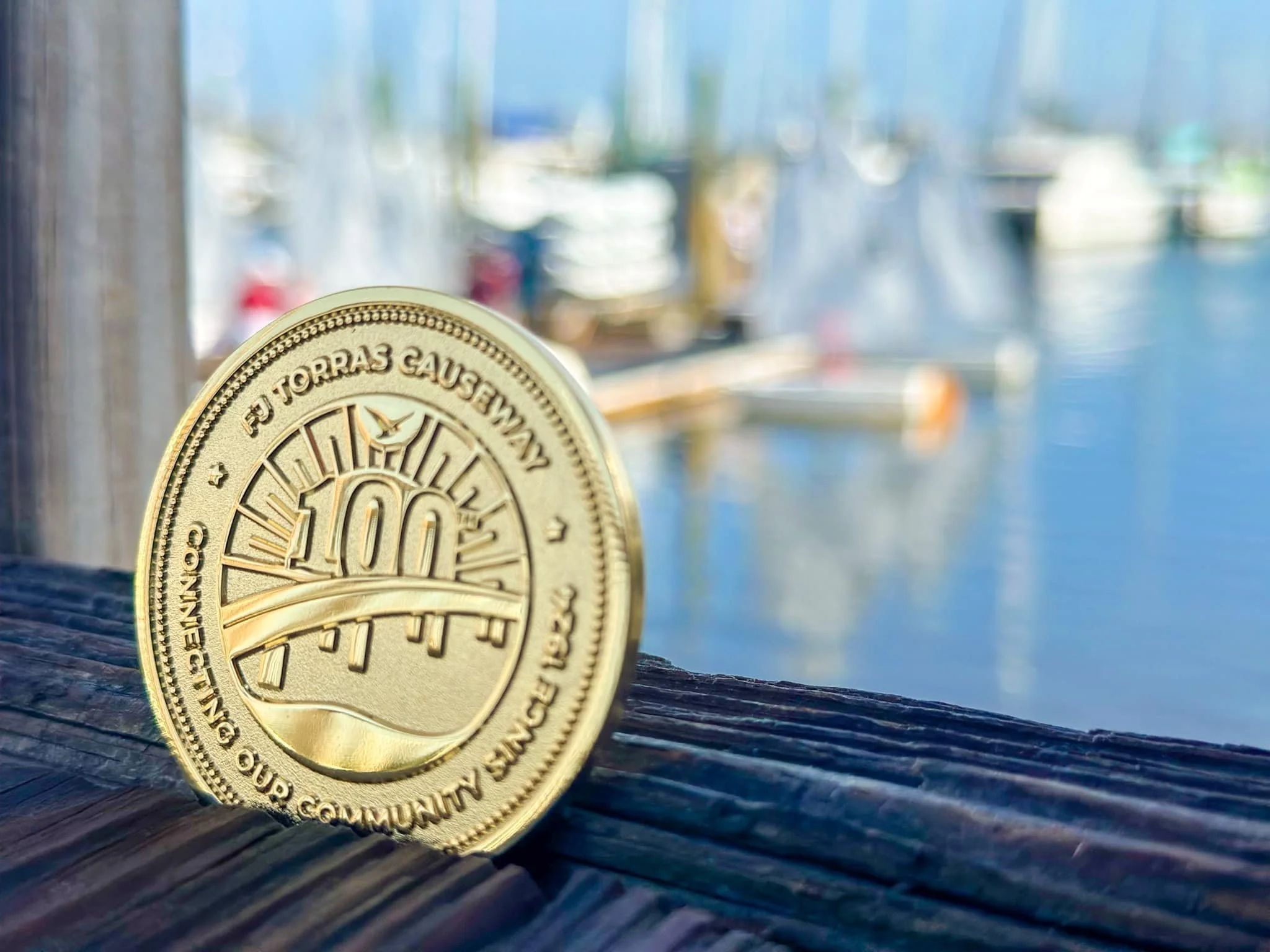 ...and we made the logo into a fancy commemorative coin, inspired by the tokens that were once used to cross the causeway.