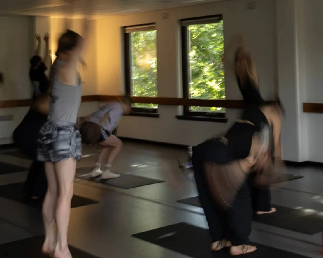 People practicing Somatic Pilates in a studio