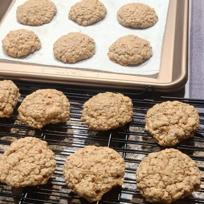 Oatmeal cookies on a baking sheet and cooling rack