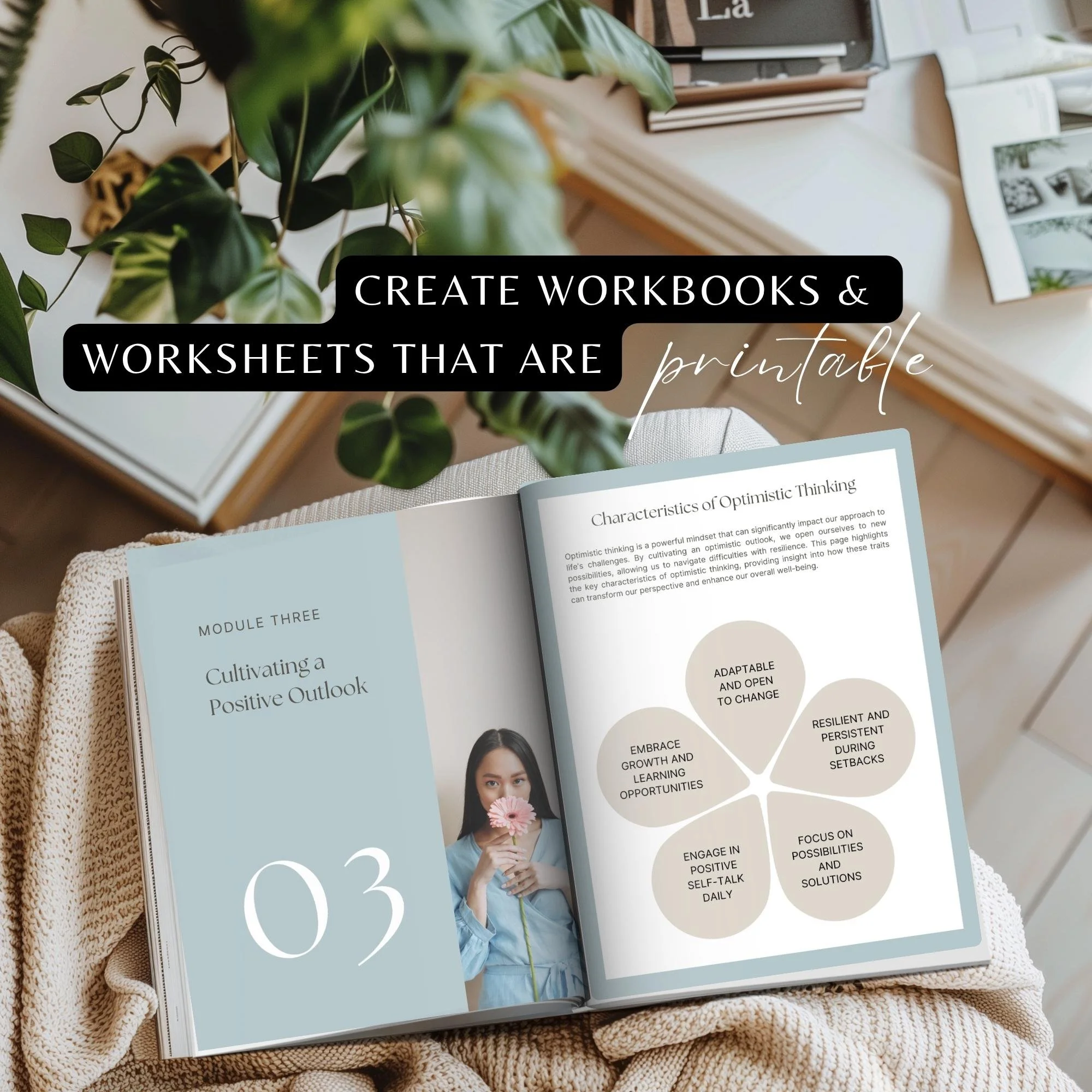 A magazine or book open on a desk with a woman on the cover holding a pink flower. Next to it is a spiral-bound workbook titled 'Characteristics of Optimistic Thinking.' There are green plants on the desk and background items including books and fram