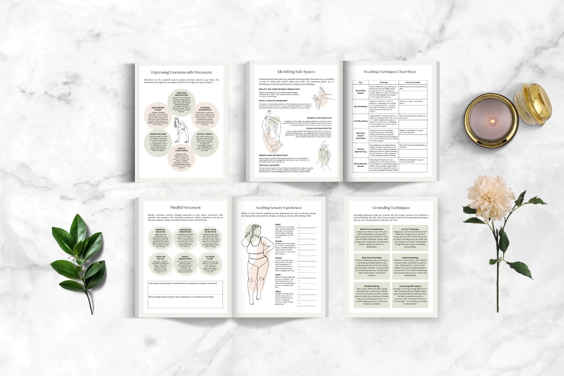 Six open booklets on a white marble surface, surrounded by two green leaves and a pink flower on the left side, and a lit candle in a glass container with a lid on the right side.