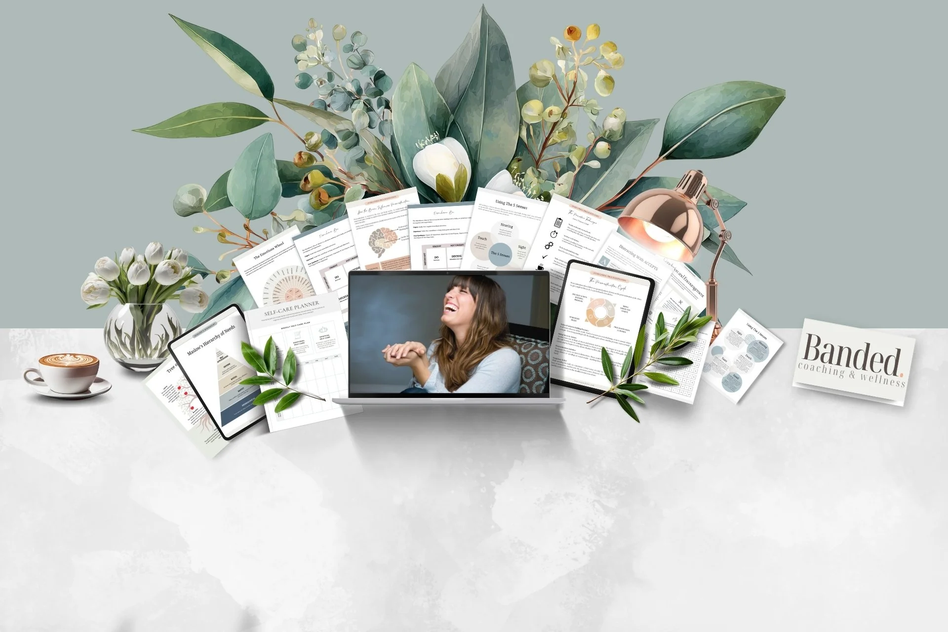 A workspace with a laptop displaying a woman laughing, surrounded by papers, a tablet, a phone, and a vase of white tulips, with leafy plants and documents in the background, and a cup of coffee on the left.