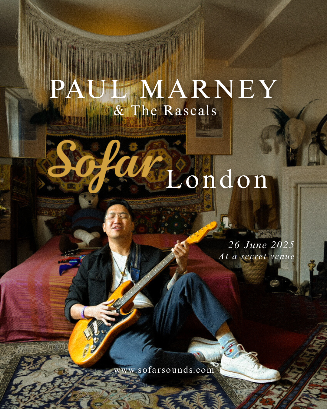 A promotional poster for a music event featuring Paul Marney & The Rascals, titled 'So Far London,' scheduled for June 26, 2025, at a secret venue. The poster shows a man sitting on a patterned rug on the floor, playing an electric guitar, with a bac