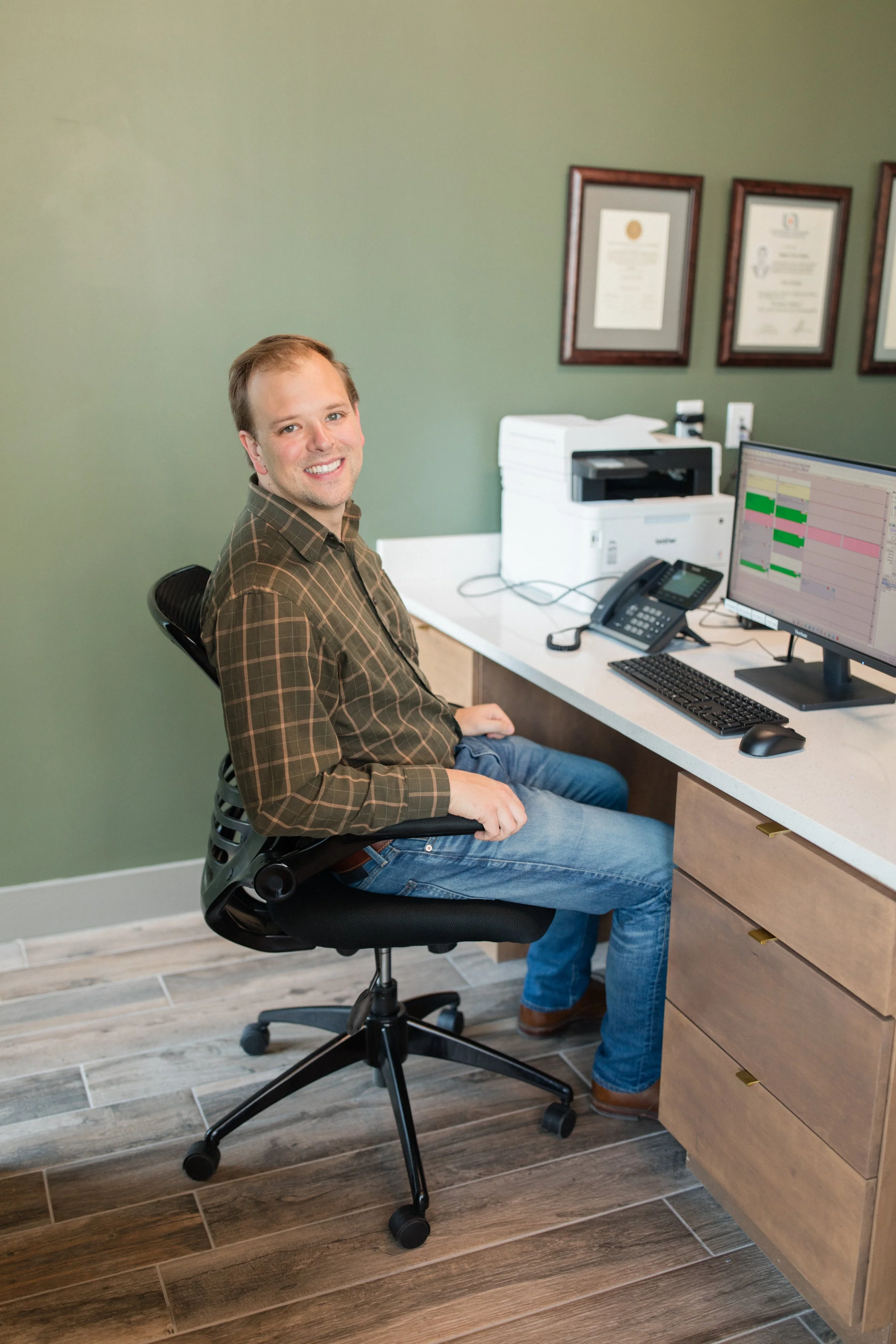 An image of Jim Dobrowolski, the practice administrator at Prickly Pear Dental Care, seated at his work station and ready to speak with patients.