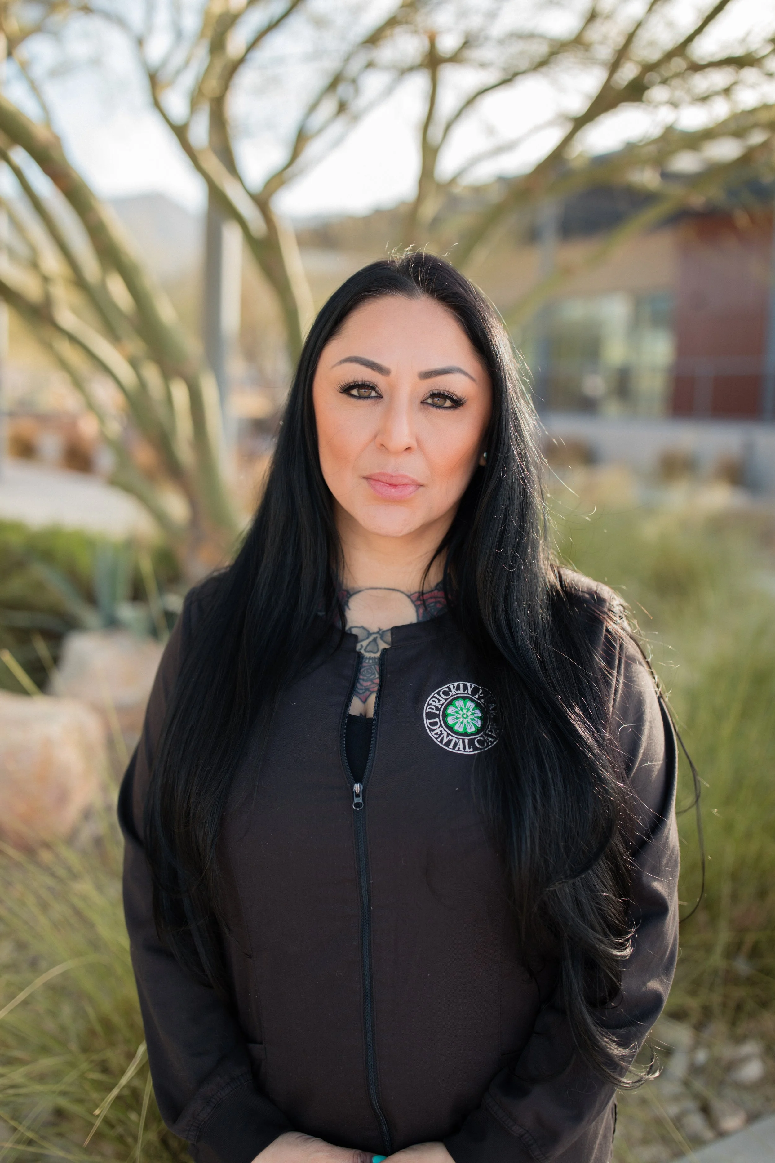 A photo of Jennifer taken in the outdoor space near the office of Prickly Pear Dental Care.
