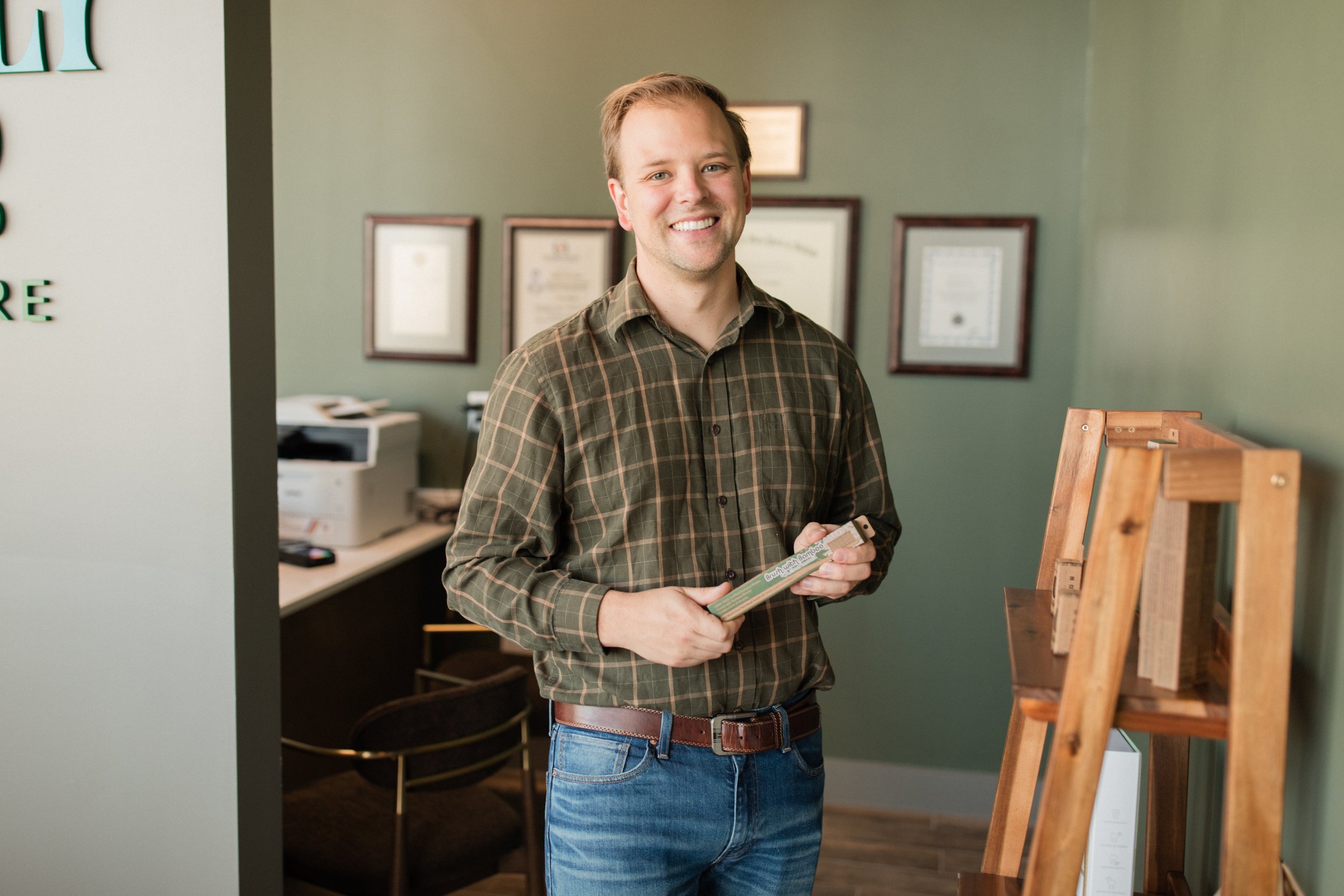 An image of Jim, the practice administrator at Prickly Pear Dental Care, standing and smiling in our front-office area.