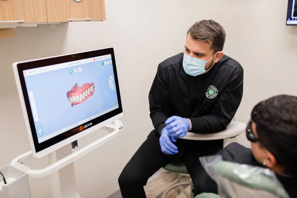 Viewing a digital scan of a patient's mouth on a Dexis scanner, one of the pieces of modern equipment utilized here at Prickly Pear Dental Care.